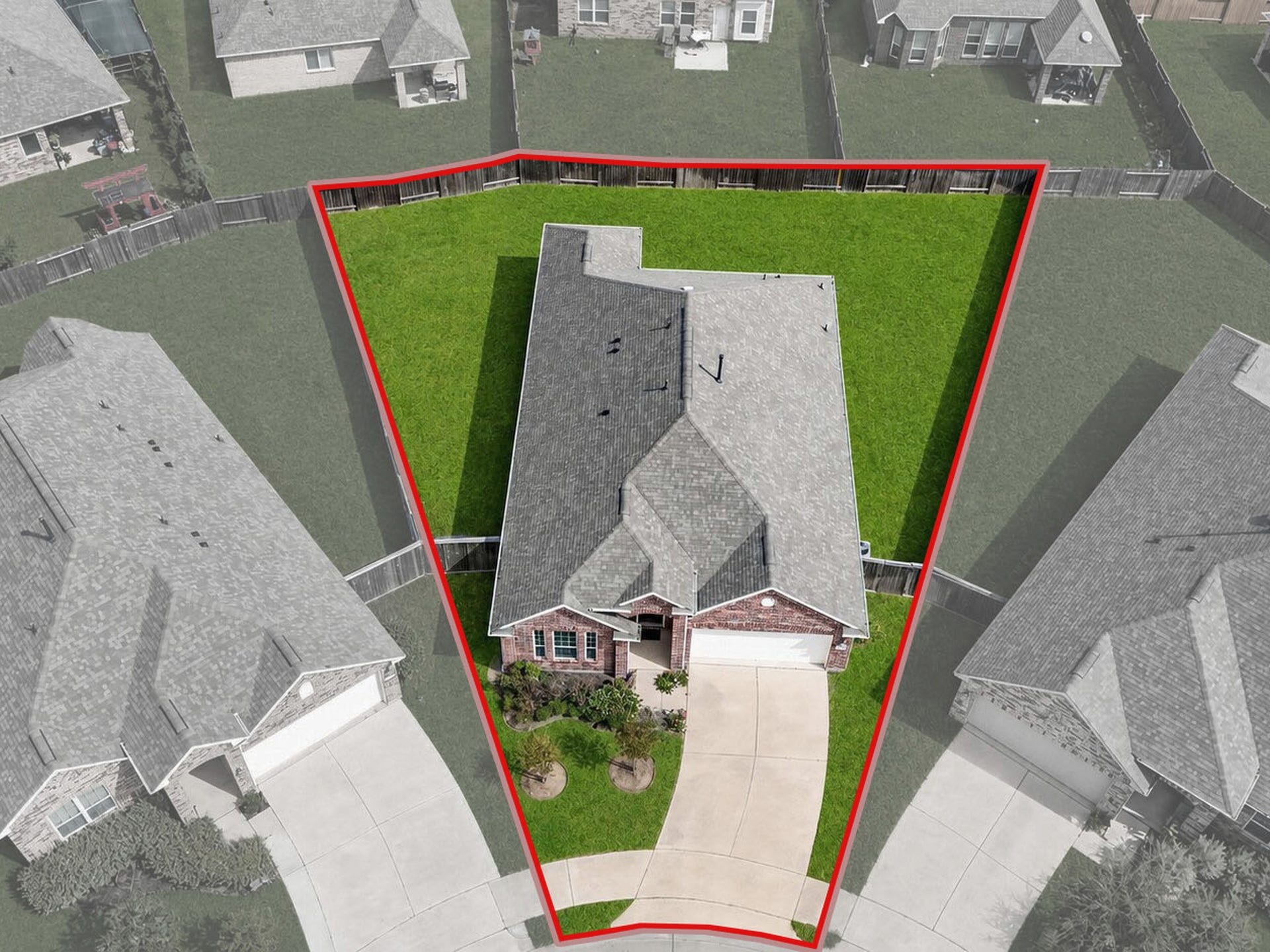 1902 Willow Ridge Ln, Fulshear, TX 77423 Front aerial view highlights the homes placement on the lot, driveway, and front lawn. Highlighted boundaries are approximate and for illustration only.