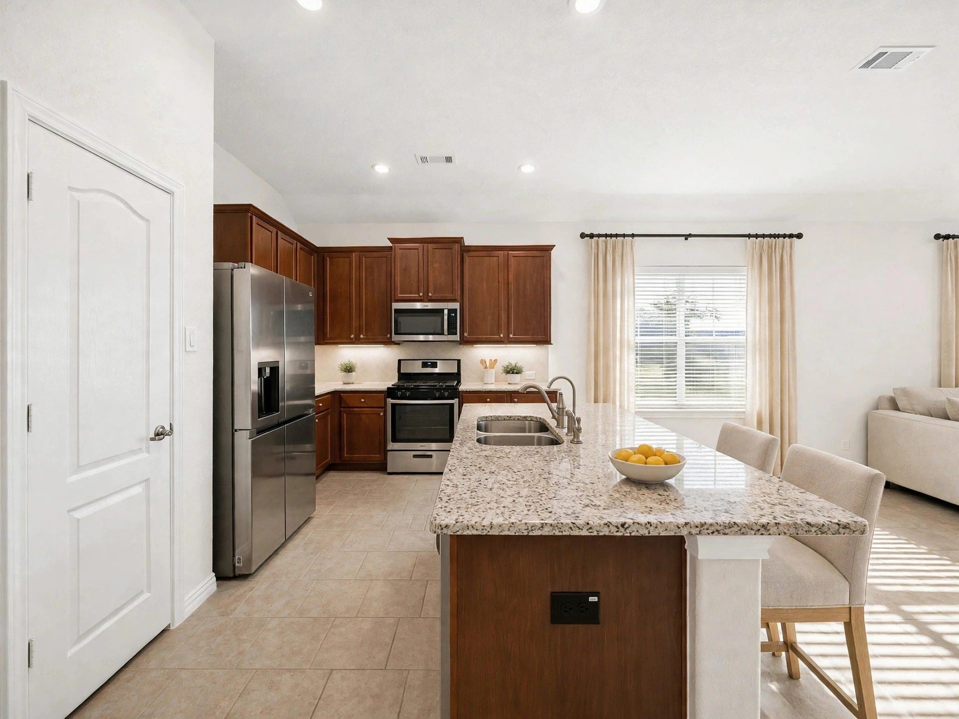 1902 Willow Ridge Ln, Fulshear, TX 77423 The kitchen features a center island, ample cabinetry, and an open connection to the living area. (Virtaully staged)