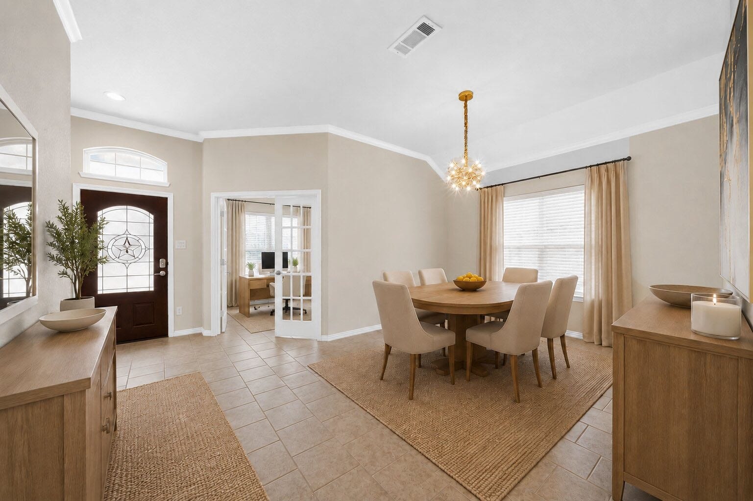 1902 Willow Ridge Ln, Fulshear, TX 77423 Virtually staged to illustrate the dining rooms layout and furnishing possibilities. Features include tile flooring, crown molding, a decorative chandelier, and a large window. French doors lead to an adjacent room.