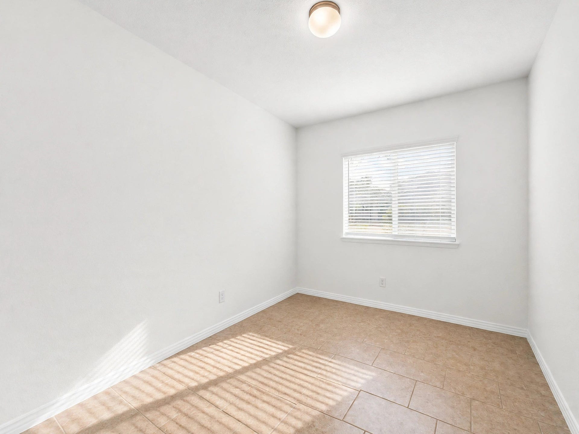1902 Willow Ridge Ln, Fulshear, TX 77423 Unfurnished secondary bedroom showcases the ample space, tile flooring, and bright space.