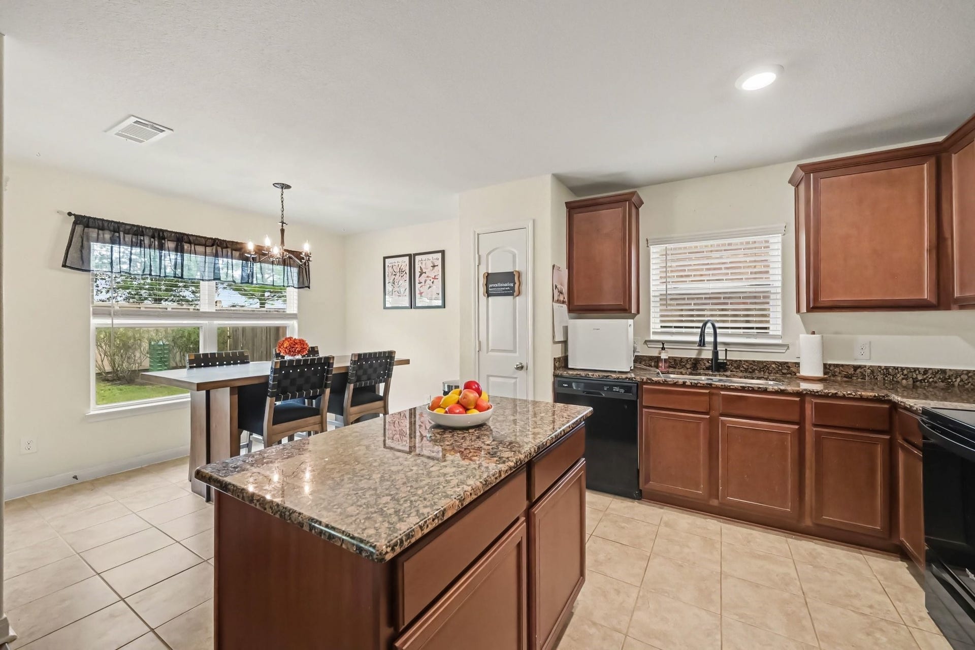 949 Texas Timbers Drive, Katy, TX 77493 Open kitchen with granite island, dining area, and ceramic tile flooring