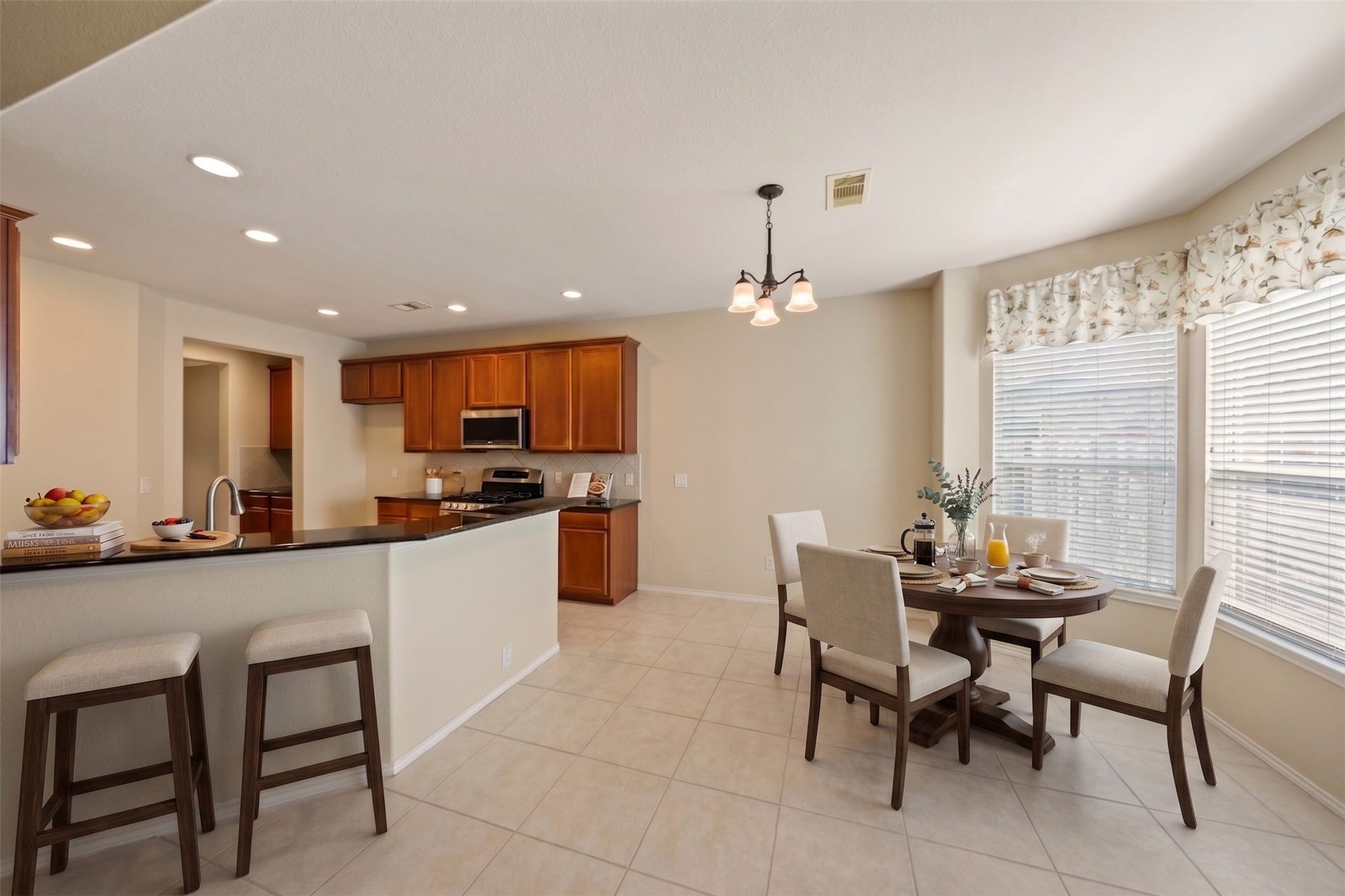 10014 Forrester Trail, Katy, TX 77494 A large breakfast and bar area expands your dining space. Virtually staged photo.
