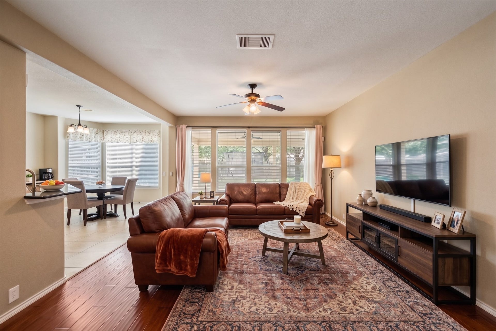 10014 Forrester Trail, Katy, TX 77494 The living room is open to the kitchen and breakfast area. Virtually staged photo.