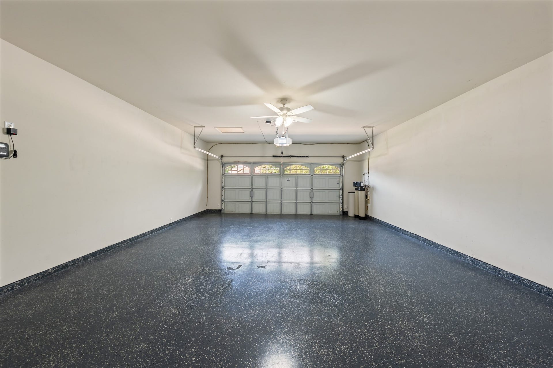 10014 Forrester Trail, Katy, TX 77494 The attached garage has an epoxy floor, houses the sprinkler system controls, and the water softener system.