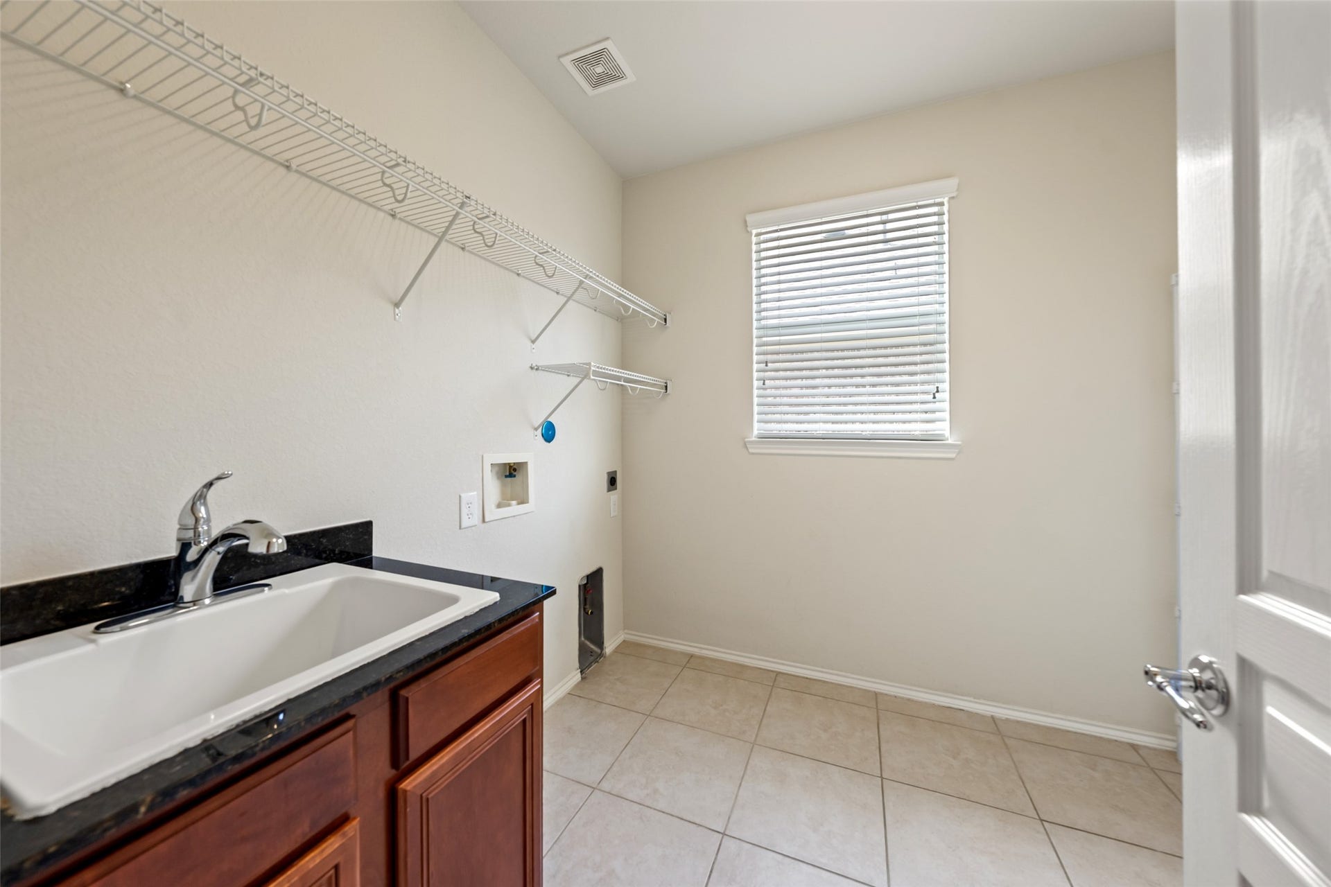 10014 Forrester Trail, Katy, TX 77494 The utility room has space for an additional refrigerator and a convenient sink set up.