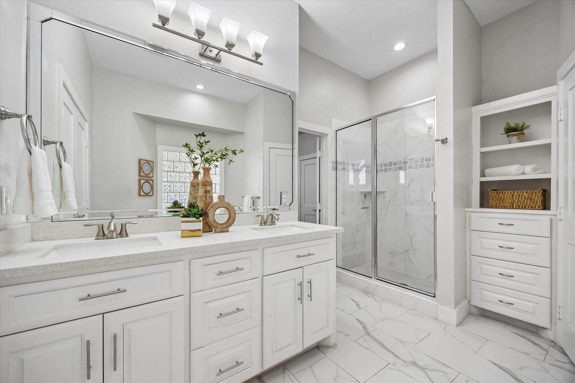702 W 41st Street, Houston, TX 77018 From busy mornings to relaxing evenings, this ensuite adds a little luxury to everyday life. Dual sinks, custom built-ins, a spacious walk-in shower and elegant finishes make it as practical as it is beautiful.