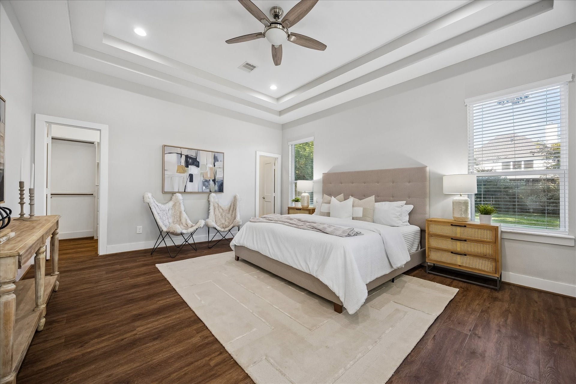 702 W 41st Street, Houston, TX 77018 Why settle for one primary suite when you can have two? This spacious bedroom offers the flexibility of a second primary or luxurious guest retreat, complete with a beautiful triple tray ceiling, updated luxury vinyl tile flooring, private ensuite and custom walk-in closet. Perfect for extended family, long-term guests or multigenerational living.