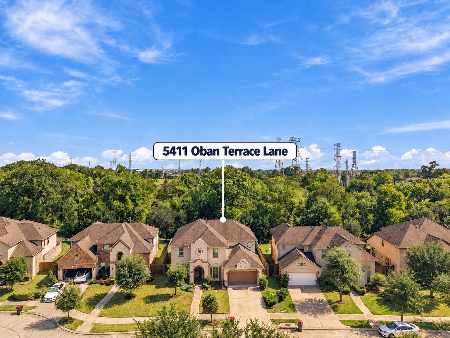 5411 Oban Terrace Lane, Sugar Land, TX 77479 An elevated view captures the charm of this residential setting, with beautifully maintained homes and a backdrop of mature greenery.