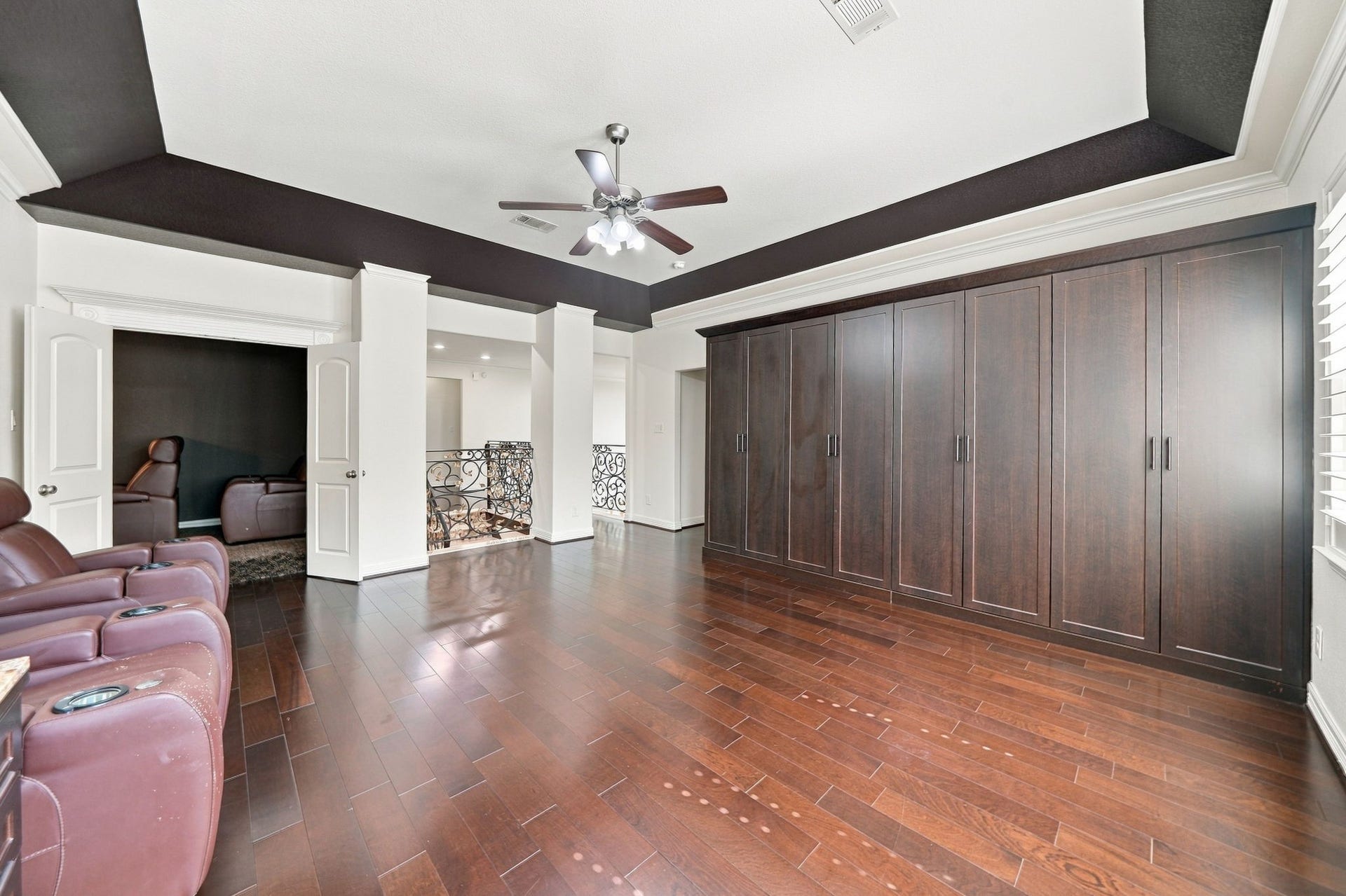 5411 Oban Terrace Lane, Sugar Land, TX 77479 A wall of built-in cabinetry adds valuable storage to this upstairs game room, keeping entertainment essentials organized and out of sight.