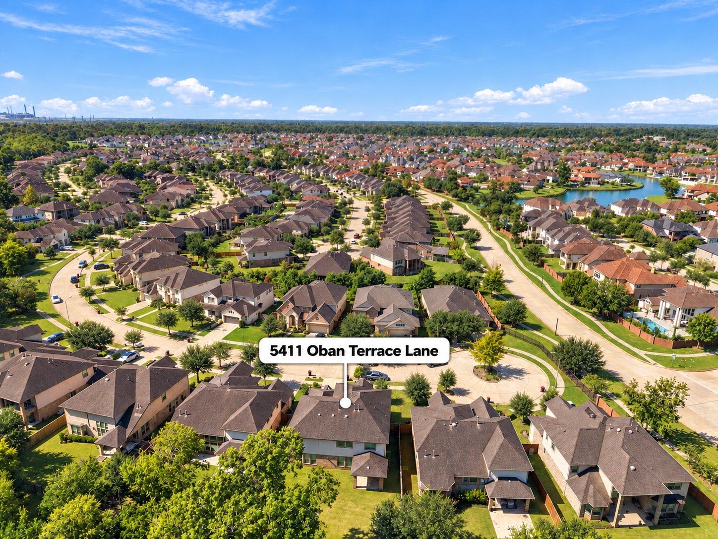 5411 Oban Terrace Lane, Sugar Land, TX 77479 This aerial view showcases the neighborhoods attractive setting, with winding streets, greenery, and a picturesque community lake nearby.