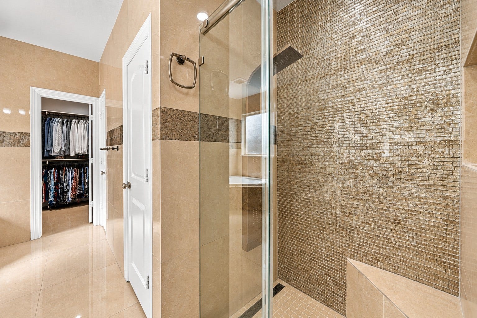 5411 Oban Terrace Lane, Sugar Land, TX 77479 Start your mornings with a refreshing rainfall-style shower, then step into the adjoining walk-in closet to get ready for the day.