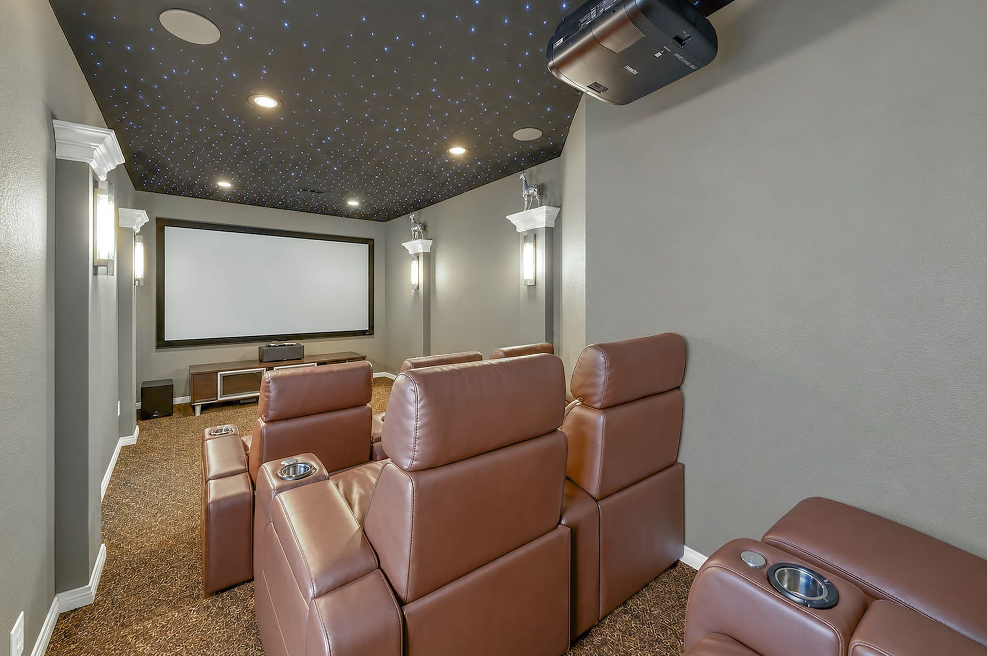 5411 Oban Terrace Lane, Sugar Land, TX 77479 A custom star-lit ceiling transforms this media room into a personal cinema, creating an unforgettable setting for movies, sports, and entertainment.
