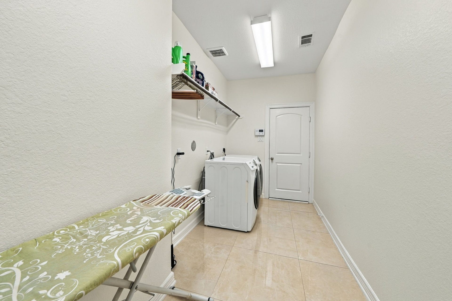 5411 Oban Terrace Lane, Sugar Land, TX 77479 Enjoy the convenience of a separate laundry room next to kitchen with overhead storage and room for ironing, keeping the rest of your home clutter-free.