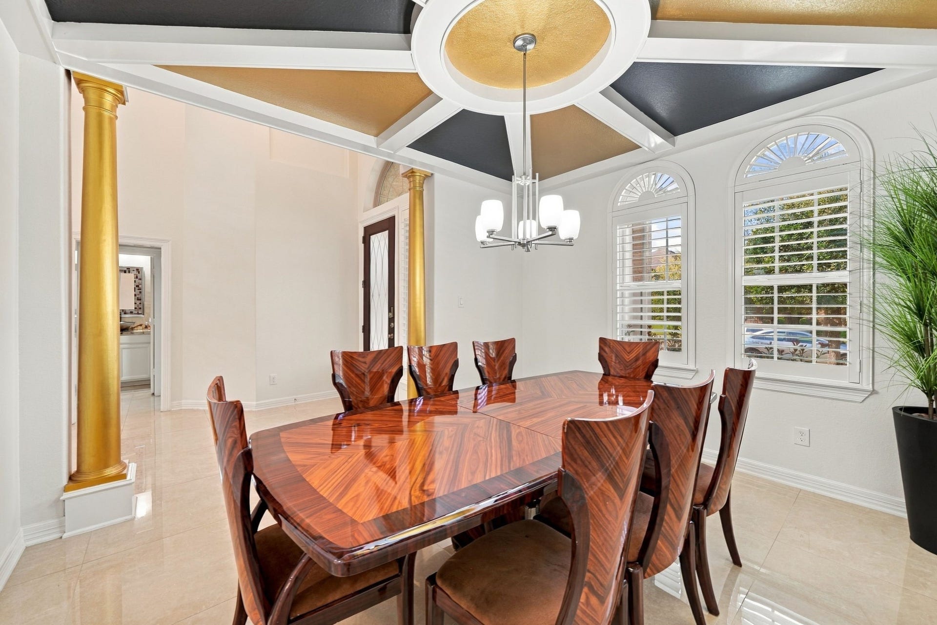 5411 Oban Terrace Lane, Sugar Land, TX 77479 Gold-accented columns, detailed ceiling craftsmanship, and natural light streaming through the windows give this formal dining room a distinctive character, creating an impressive setting for hosting family and friends.