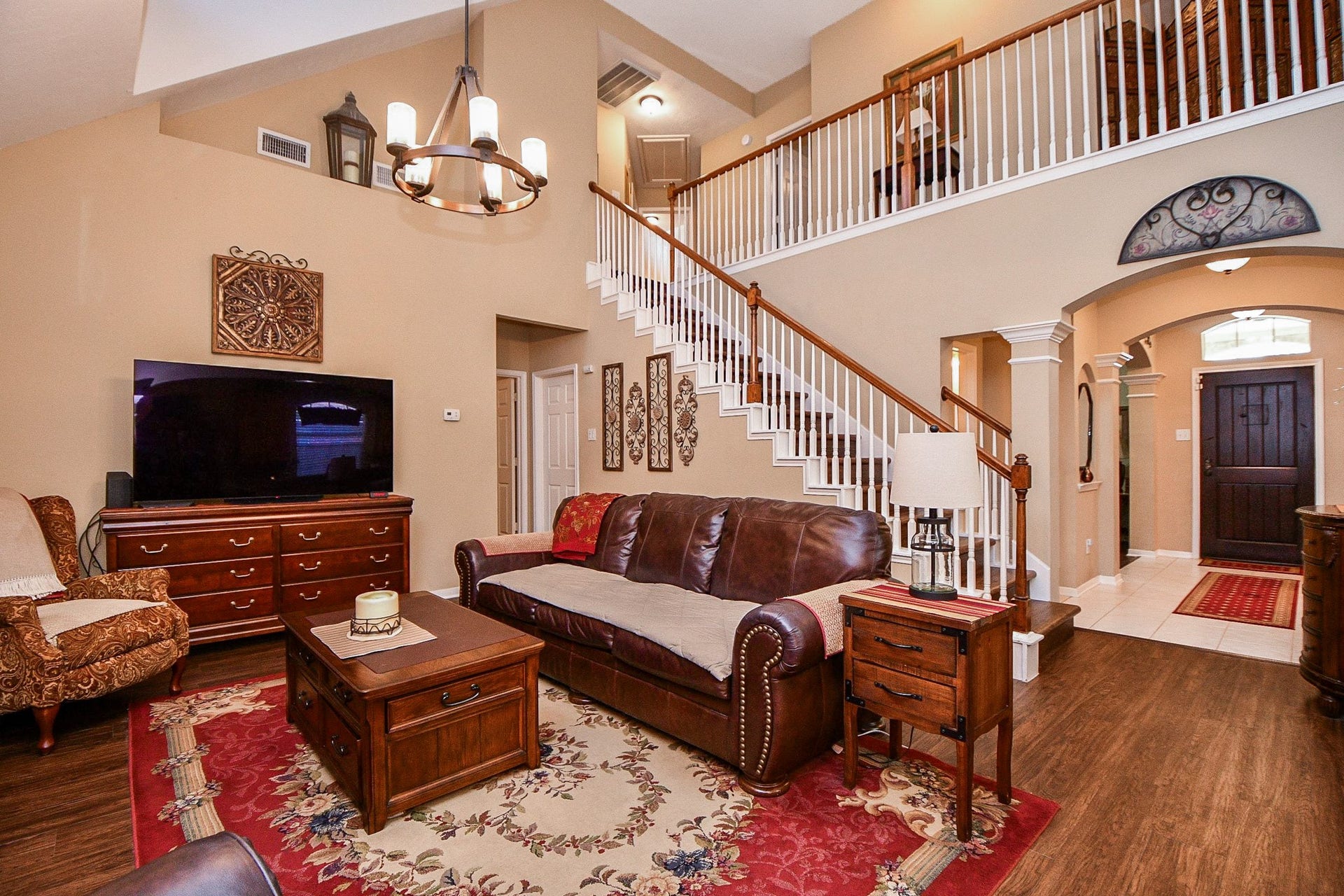 Look up and appreciate the dramatic two-story ceiling and open staircase overlooking the family room. This spacious gathering area offers an impressive sense of openness while remaining connected to the surrounding living spaces.