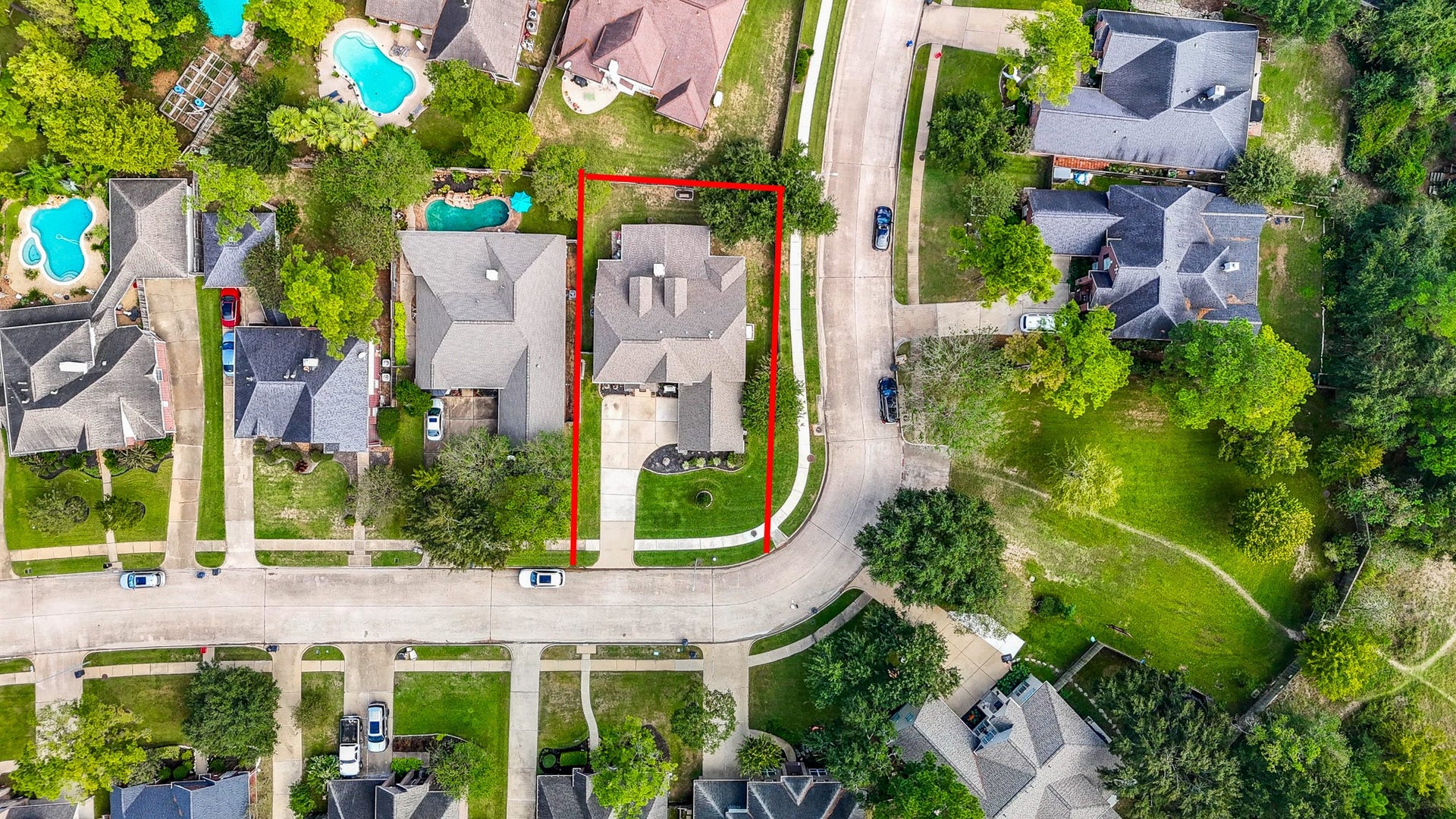 From directly above, you can appreciate the home's footprint, driveway, fenced backyard, and corner-lot position. A great perspective on how the outdoor spaces are arranged around the home.