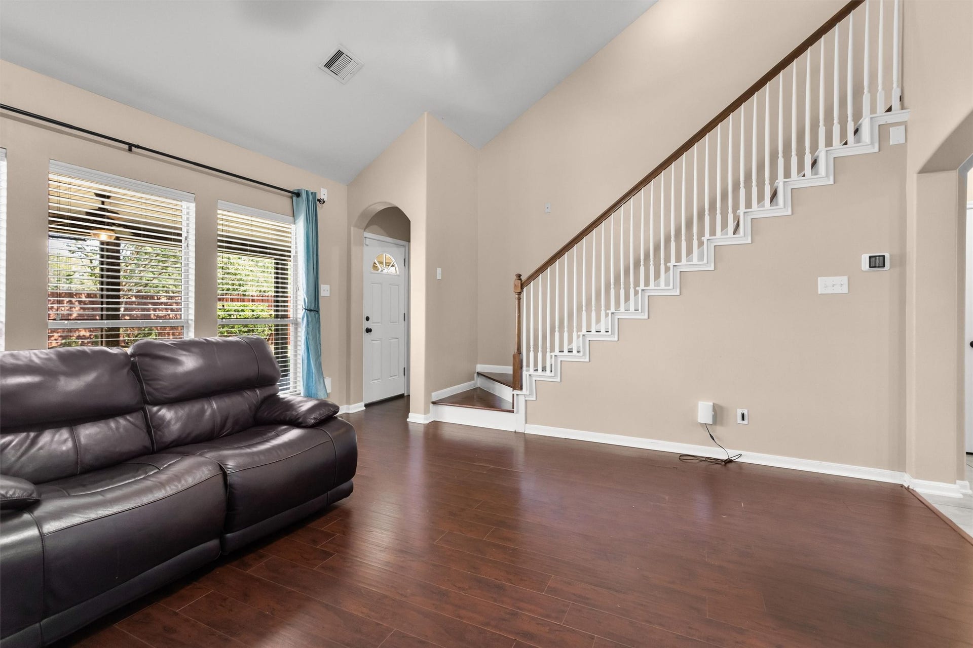20514 Rustic Rail Court, Cypress, TX 77433 Hallway off the living room leads to the primary bedroom. Updated wood stairs.