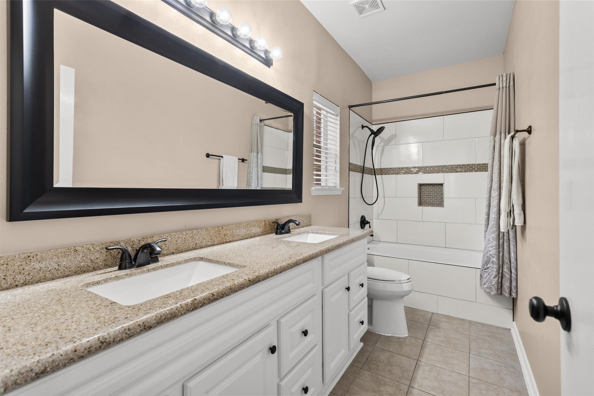 20514 Rustic Rail Court, Cypress, TX 77433 Primary bathroom with granite counters, double sinks and combined tub/shower