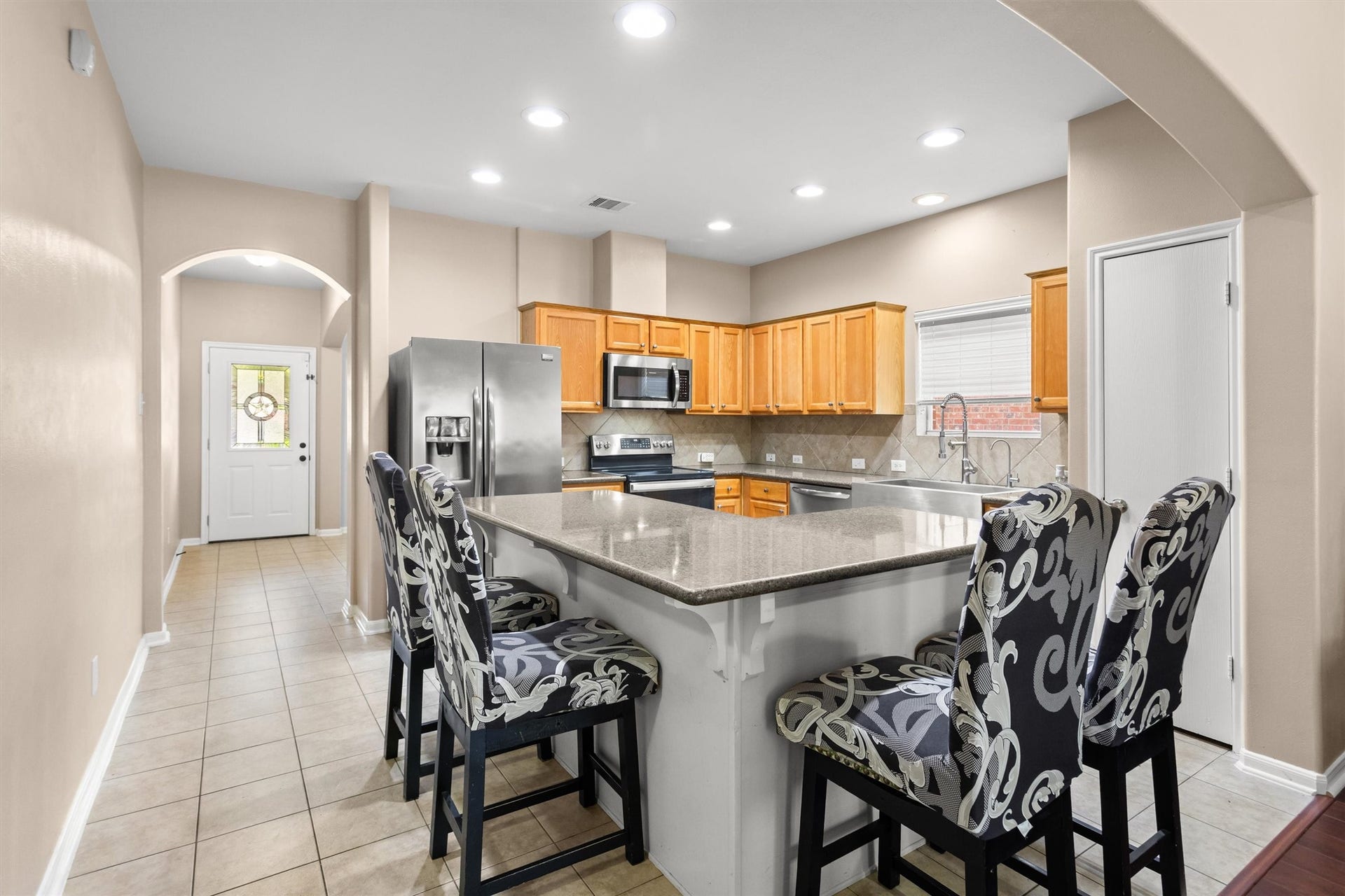 20514 Rustic Rail Court, Cypress, TX 77433 Entry leads into central kitchen.