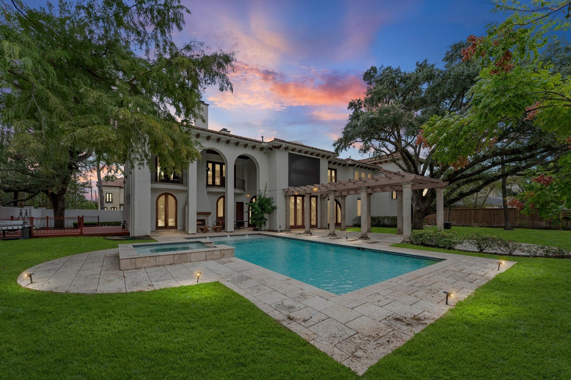 5135 Longmont Drive, Houston, TX 77056 Experience the beauty of timeless Modern Spanish architecture, where expansive travertine pool decking, a custom pool and raised spa, and a grand pergola create an extraordinary outdoor retreat. Framed by mature trees and elegant architectural details, this private oasis invites you to relax, entertain, and enjoy luxury living at its finest.