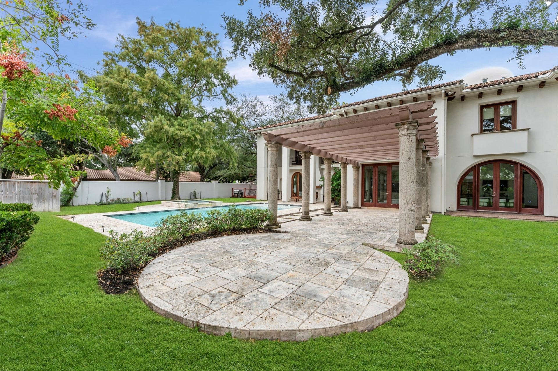 5135 Longmont Drive, Houston, TX 77056 A private patio tucked at the end of the pergola offers an additional outdoor seating or dining destination surrounded by the estate's landscaped grounds.