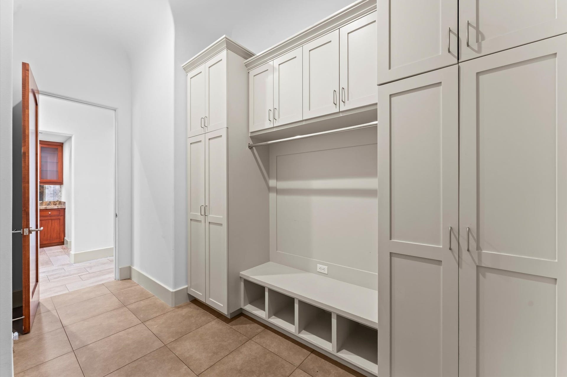 5135 Longmont Drive, Houston, TX 77056 An oversized mudroom featuring custom built-in shelving and abundant storage, designed to keep everyday essentials organized while maintaining a seamless flow throughout the home.