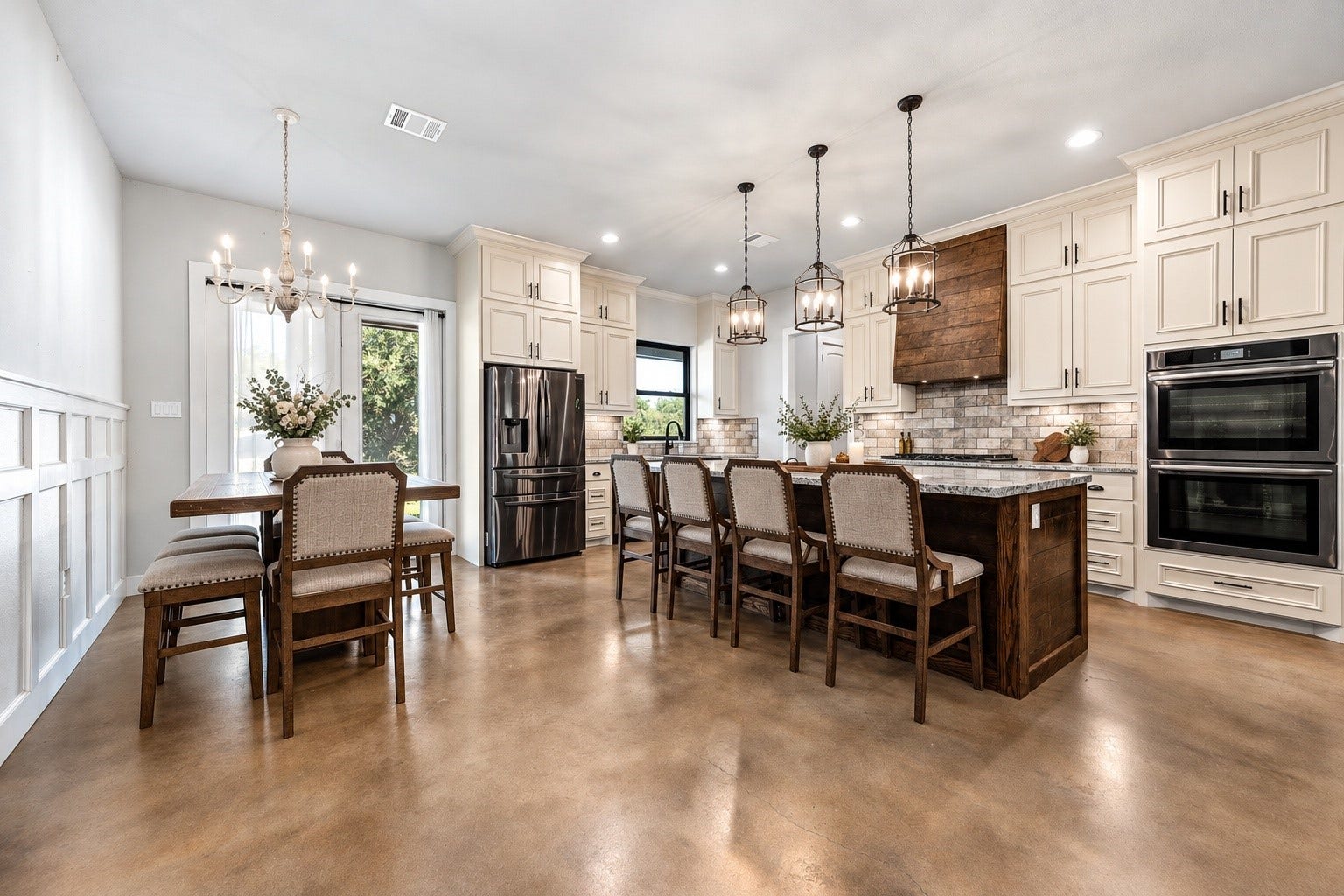 3295 Fm 524 Road, Sweeny, TX 77480 Dining area open to the kitchen, with wainscoting, pendant lighting, granite island and double wall ovens. This photo may be edited using AI tools.