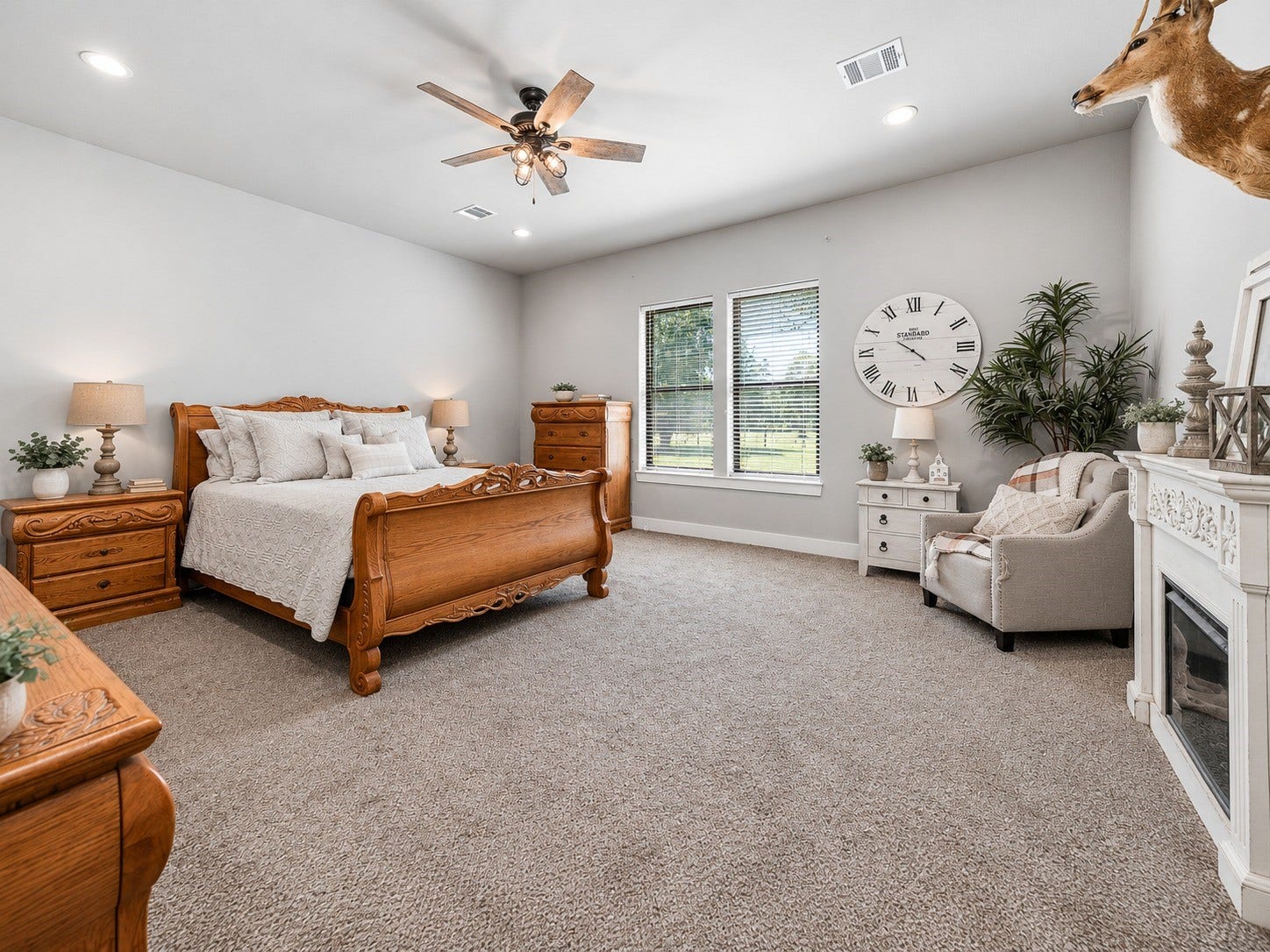 3295 Fm 524 Road, Sweeny, TX 77480 Spacious primary bedroom with carpet, ceiling fan and large windows overlooking the property. This photo may be edited using AI tools.