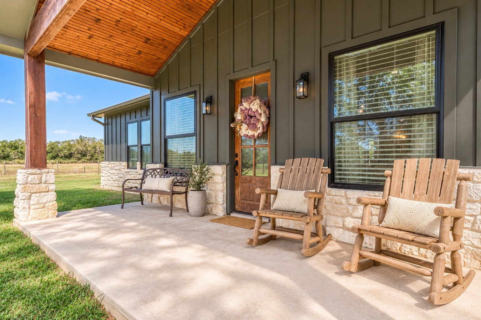 3295 Fm 524 Road, Sweeny, TX 77480 Covered front porch with cedar posts, stone wainscot and room for rocking chairs, overlooking the front pasture. This photo may be edited using AI tools.