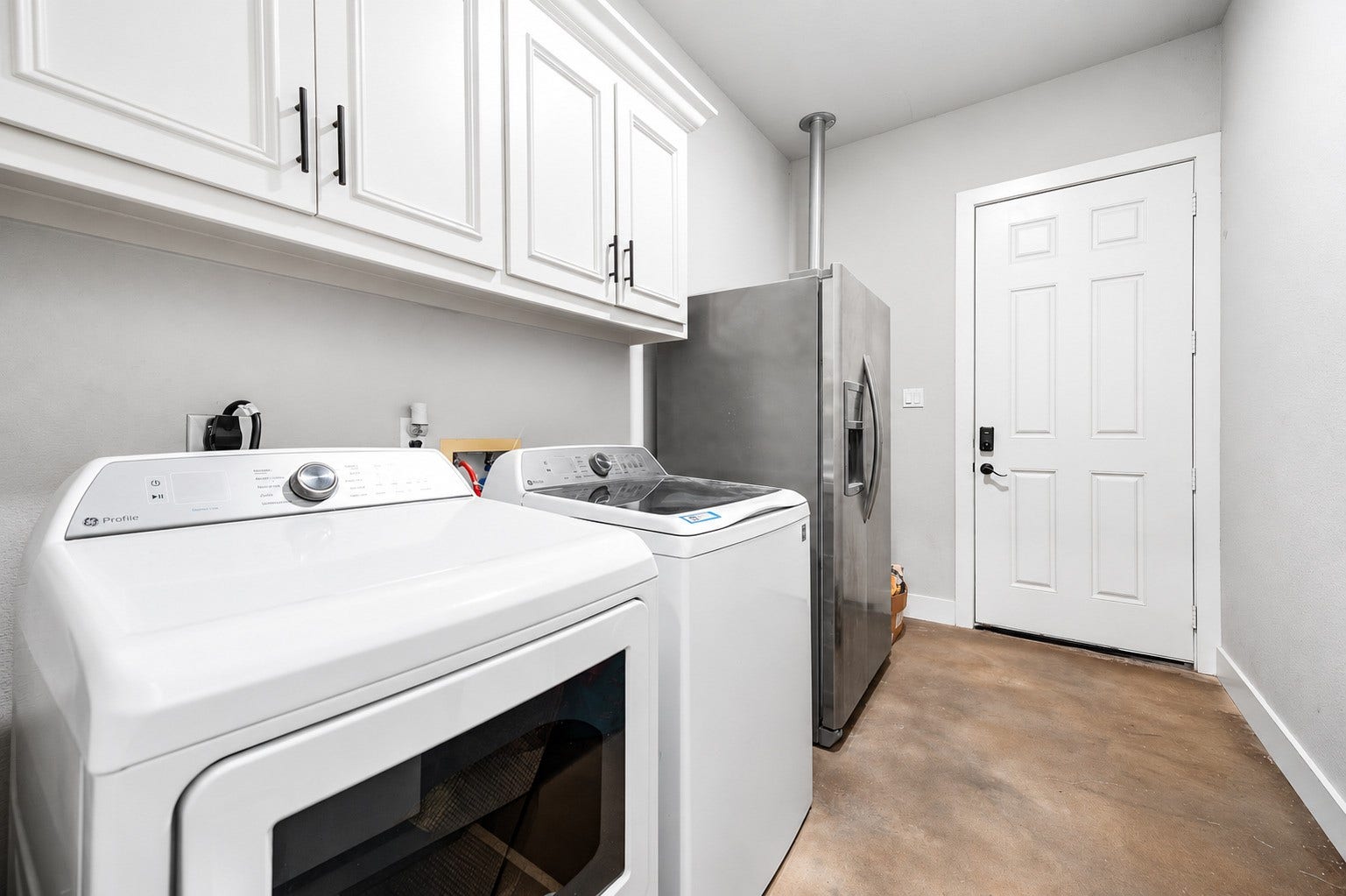 3295 Fm 524 Road, Sweeny, TX 77480 Laundry room with upper cabinets and space for a full-size washer and dryer. This photo may be edited using AI tools.