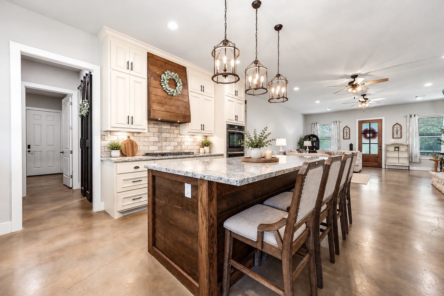 3295 Fm 524 Road, Sweeny, TX 77480 Kitchen island with granite countertops, bar seating and pendant lights, open to the dining and family rooms. This photo may be edited using AI tools.