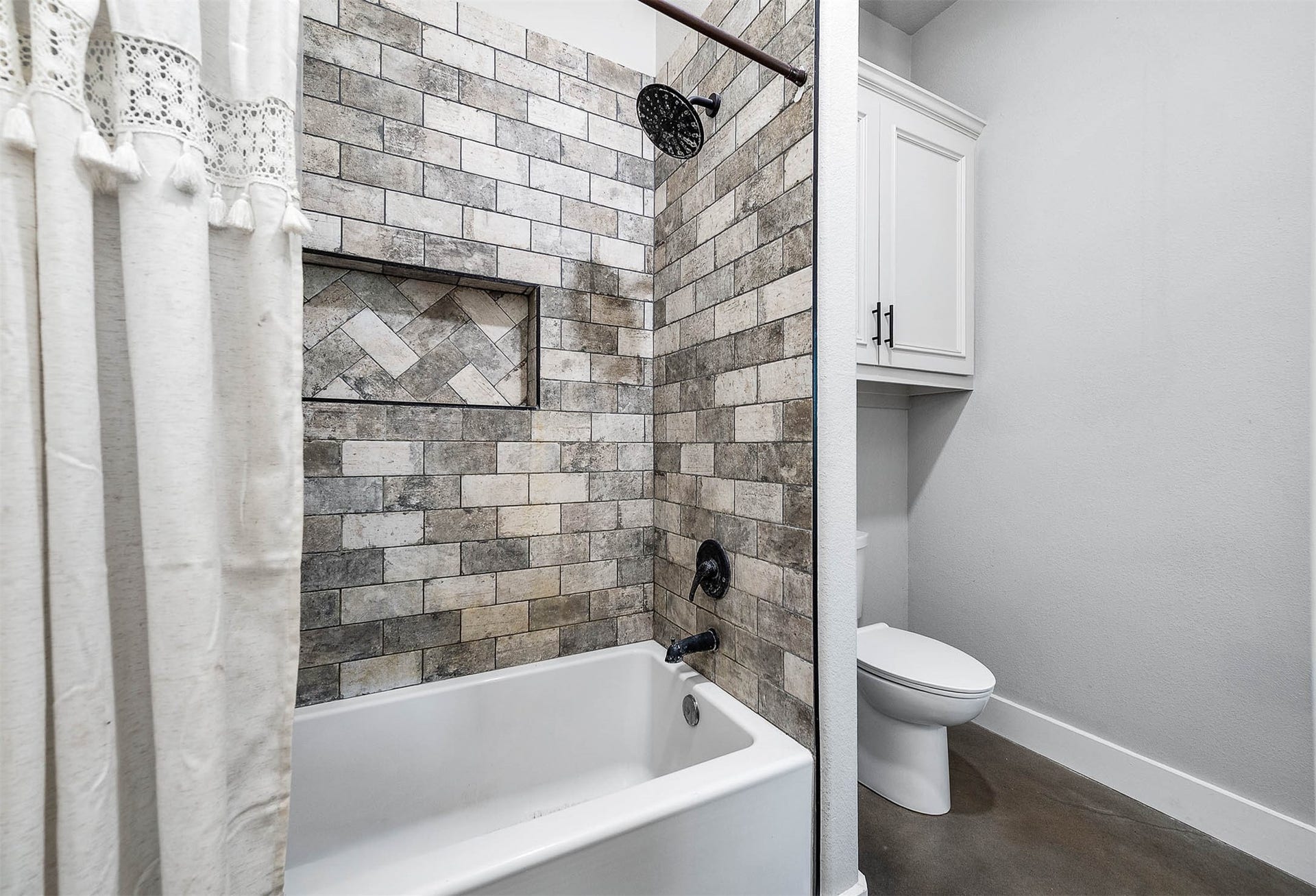 3295 Fm 524 Road, Sweeny, TX 77480 Full bathroom with tub and shower combination and tile surround. This photo may be edited using AI tools.