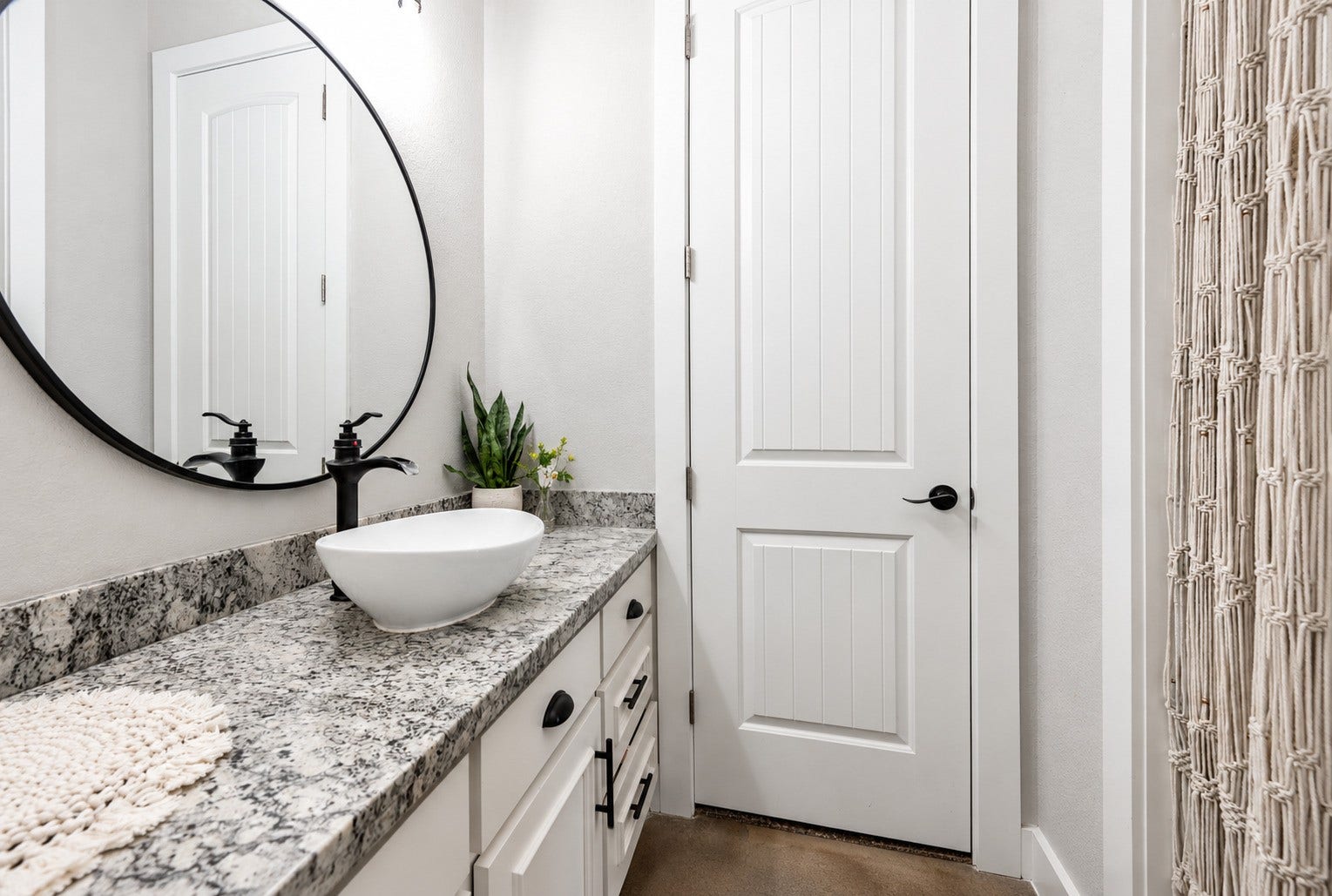 3295 Fm 524 Road, Sweeny, TX 77480 Bathroom with vessel sink, granite vanity and round mirror. This photo may be edited using AI tools.