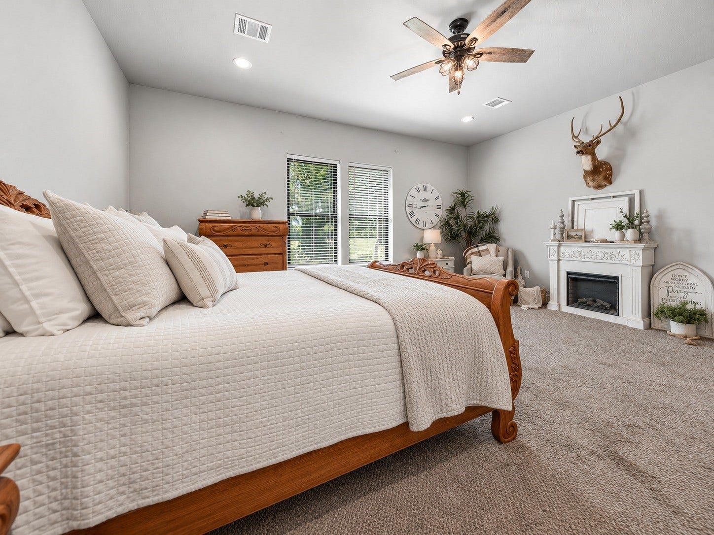 3295 Fm 524 Road, Sweeny, TX 77480 Primary bedroom with room for a king bed and sitting area, plus a decorative fireplace mantel. This photo may be edited using AI tools.