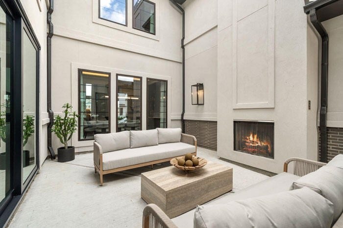 7114 Quaker Meadows Drive, Katy, TX 77493 The stylish interior courtyard, equipped with an outdoor fireplace. Representative image.