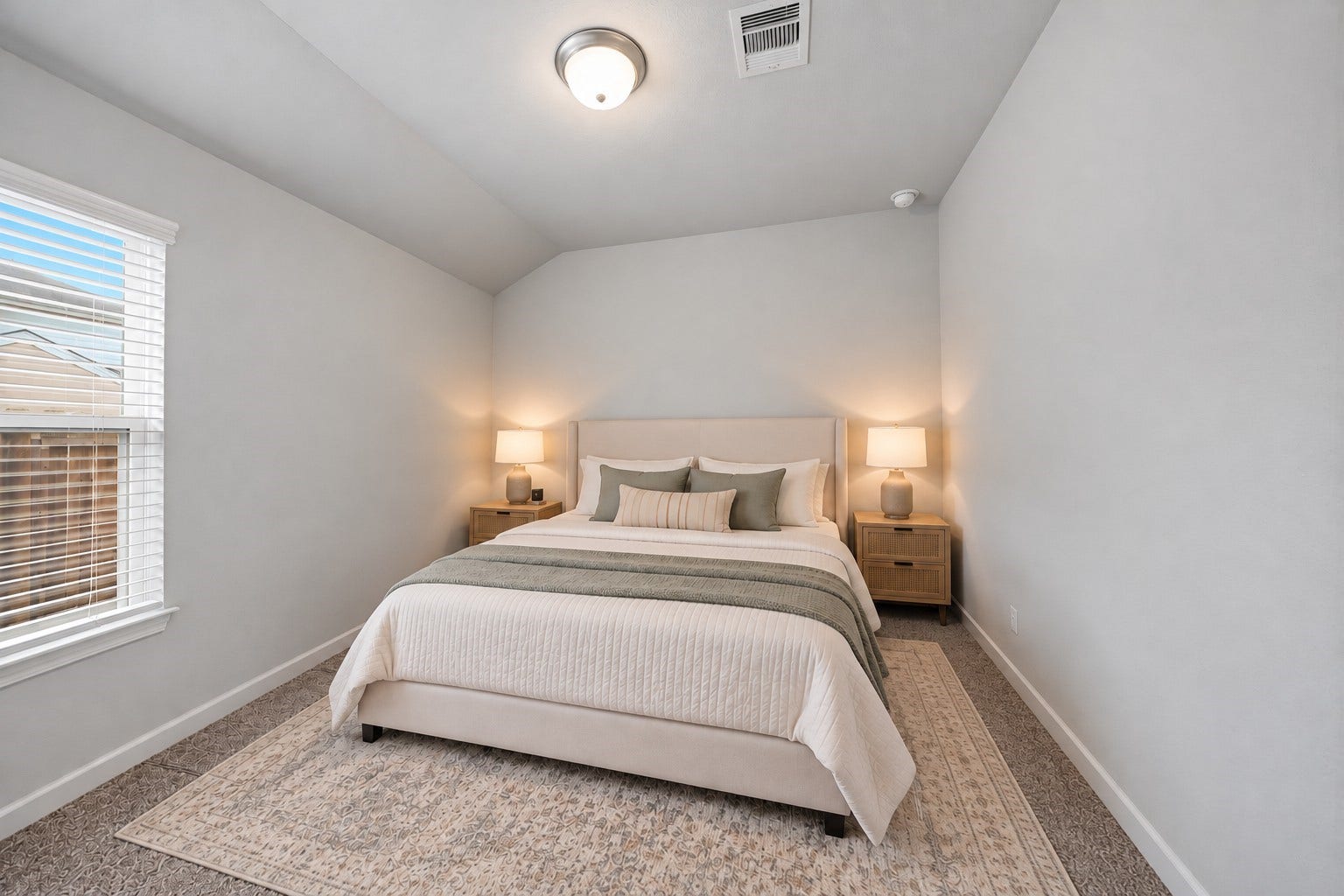 903 Pismo Lane, Rosharon, TX 77583 Virtually Staged: This inviting secondary bedroom features a vaulted ceiling, soft neutral walls, and plush carpeting that creates a comfortable, welcoming atmosphere. A large window allows abundant natural light to brighten the space.