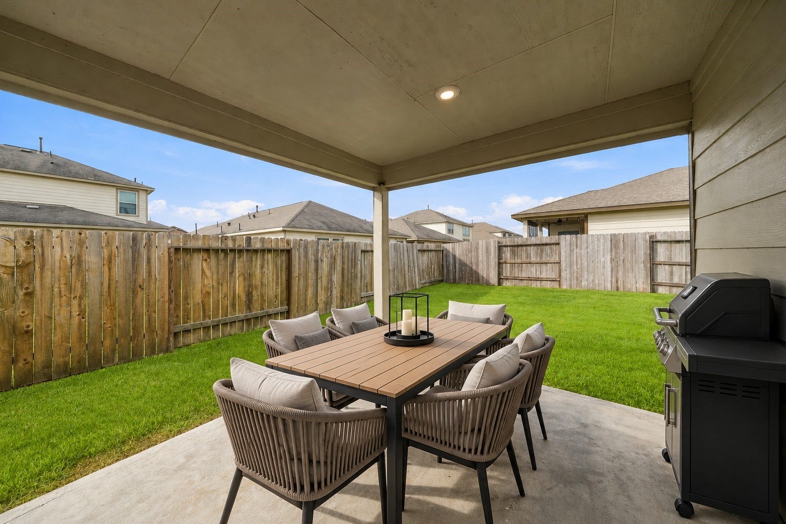 903 Pismo Lane, Rosharon, TX 77583 From this vantage point, you have a beautiful view of an expansive, lush green grass backyard, bordered by a wooden fence providing more privacy.