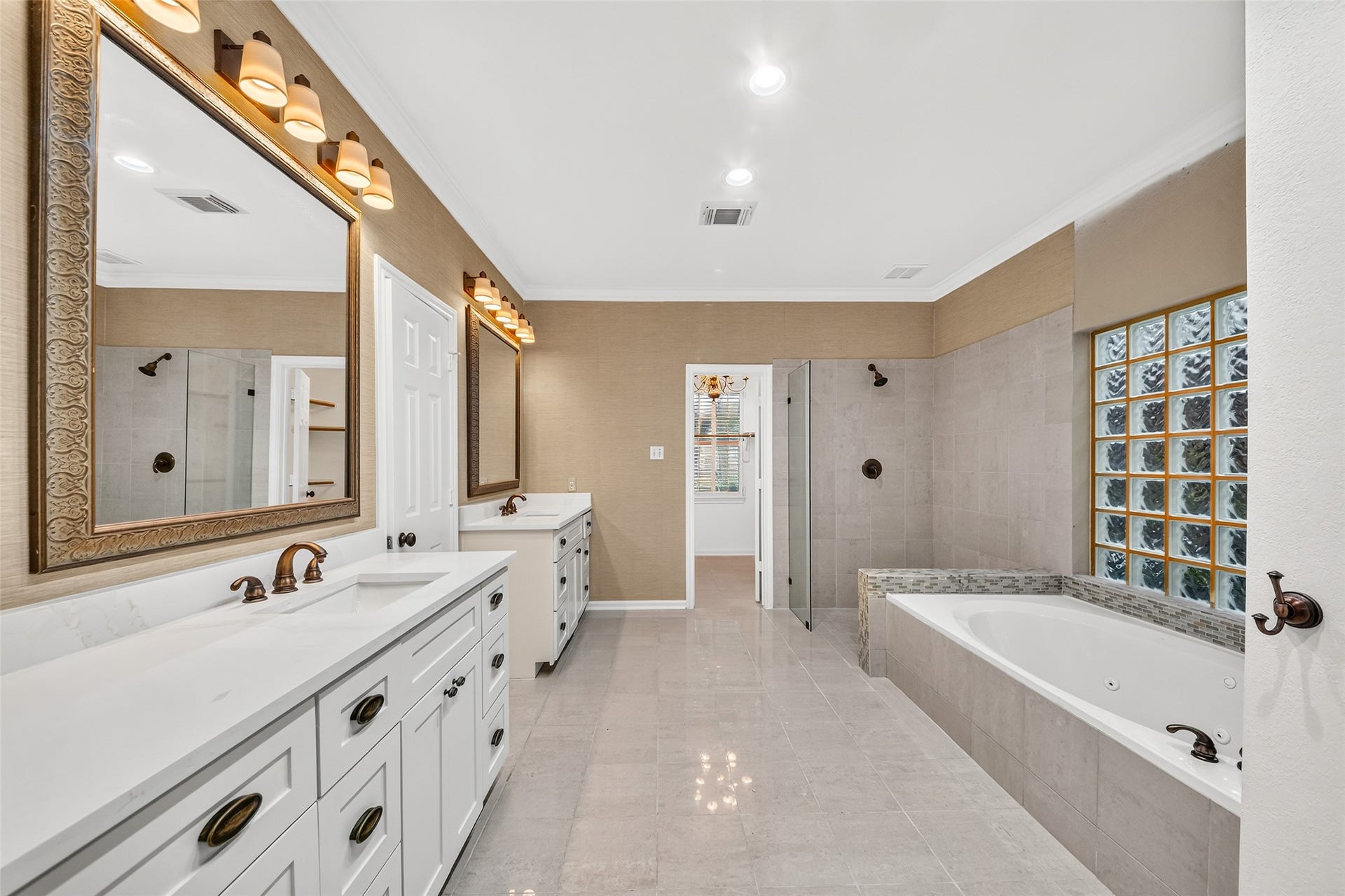 9515 Sotherloch Lake Drive, Spring, TX 77379 NEW Shaker style dual vanities with bronze hardware in the primary bath.
