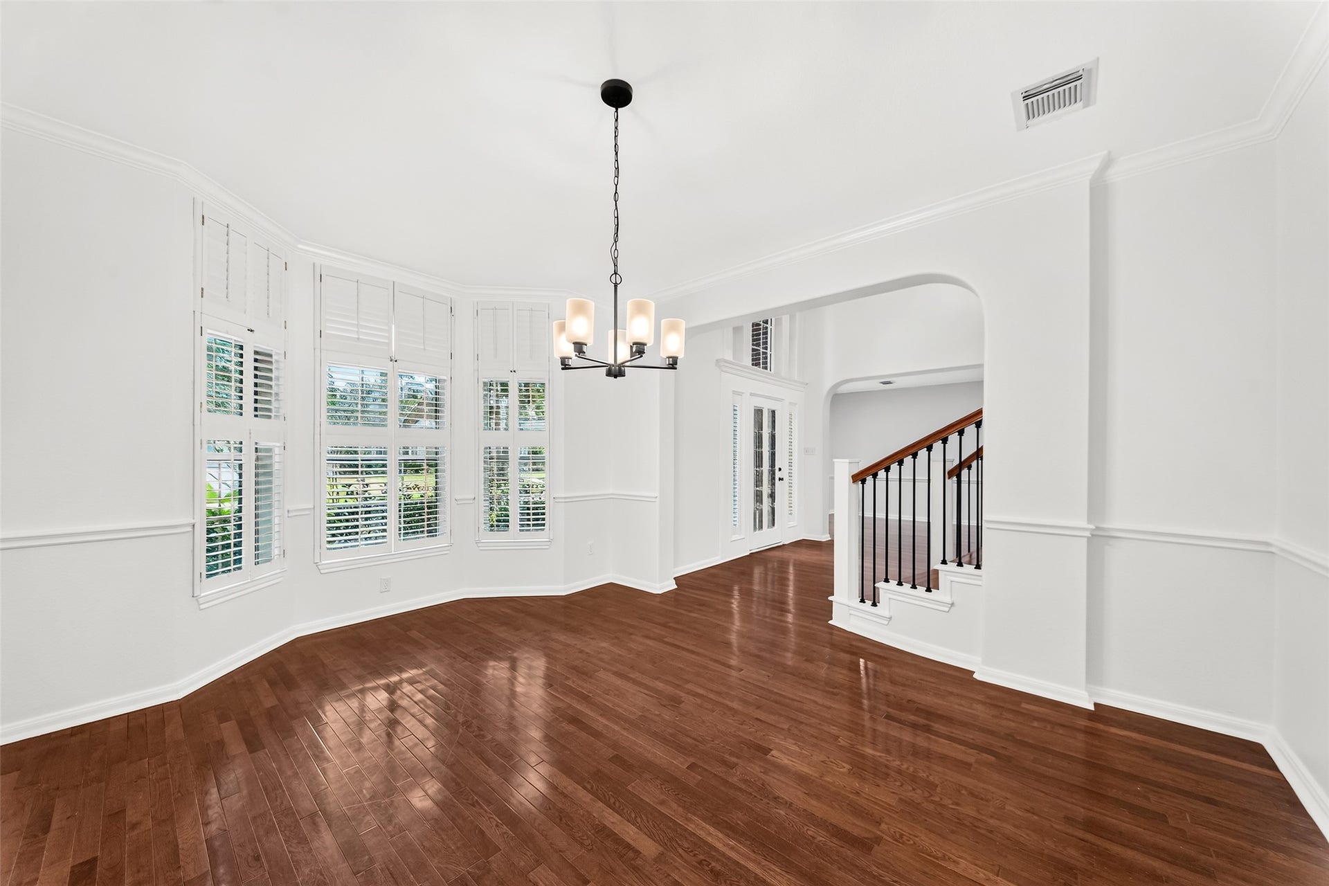 9515 Sotherloch Lake Drive, Spring, TX 77379 Formal dining room with plantation shutters and new chandelier. Hardwood floors throughout all the main living areas.