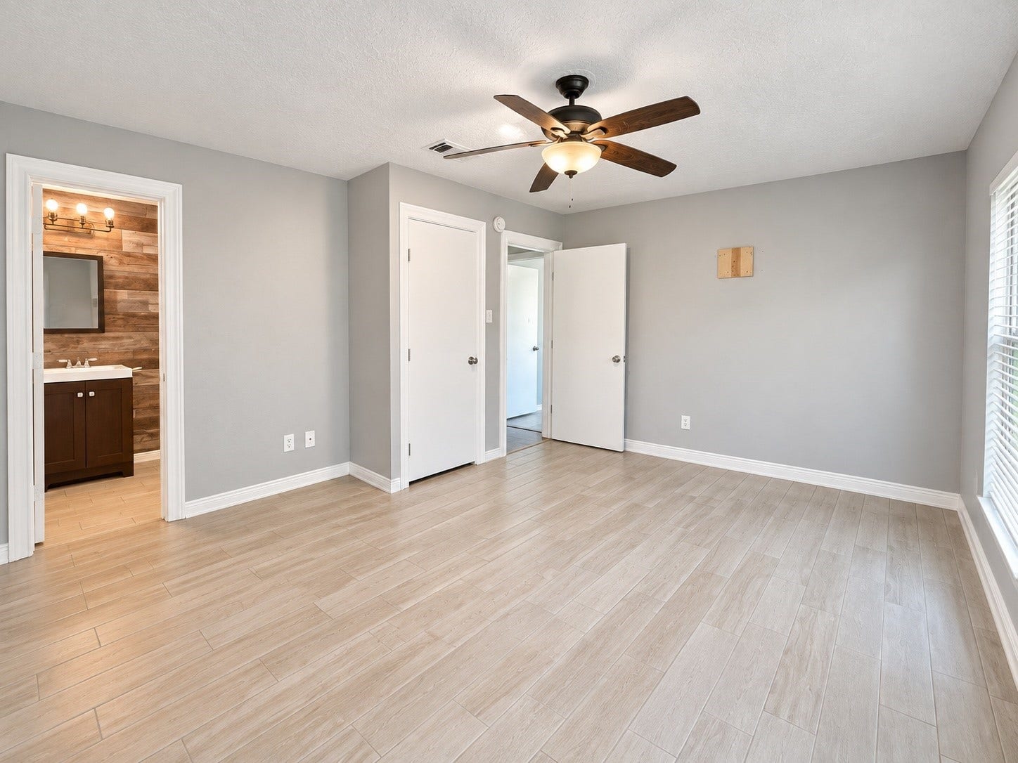 7407 Woodnettle Lane, Houston, TX 77086 Master bedroom with wood look tile flooring