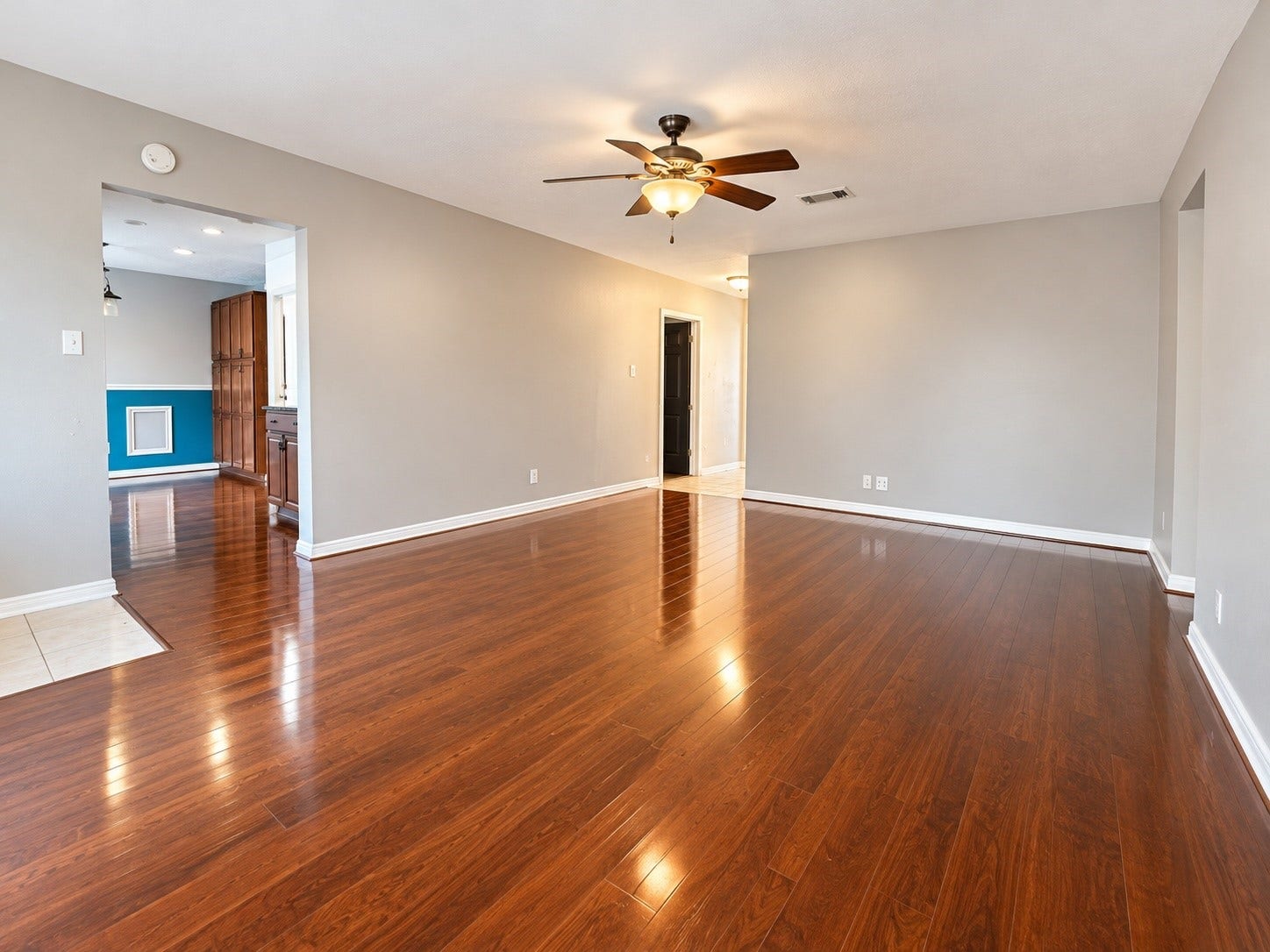 7407 Woodnettle Lane, Houston, TX 77086 Living area has ceiling fan and wood flooring