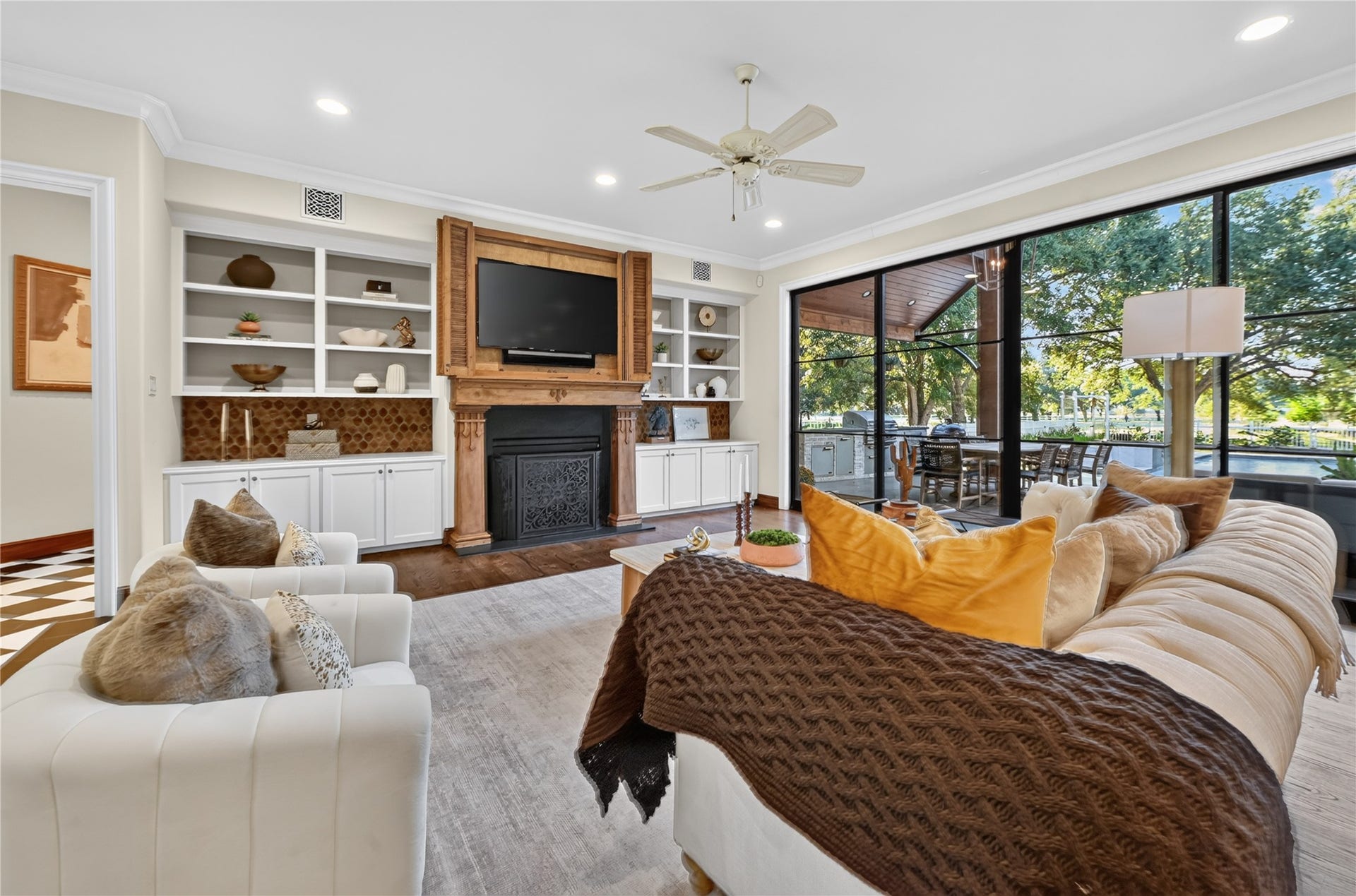 4510 River Forest Drive, Richmond, TX 77406 Cozy living opens to expansive views of the the backyard, complete with industrial sliding doors and surround sound for entertaining.