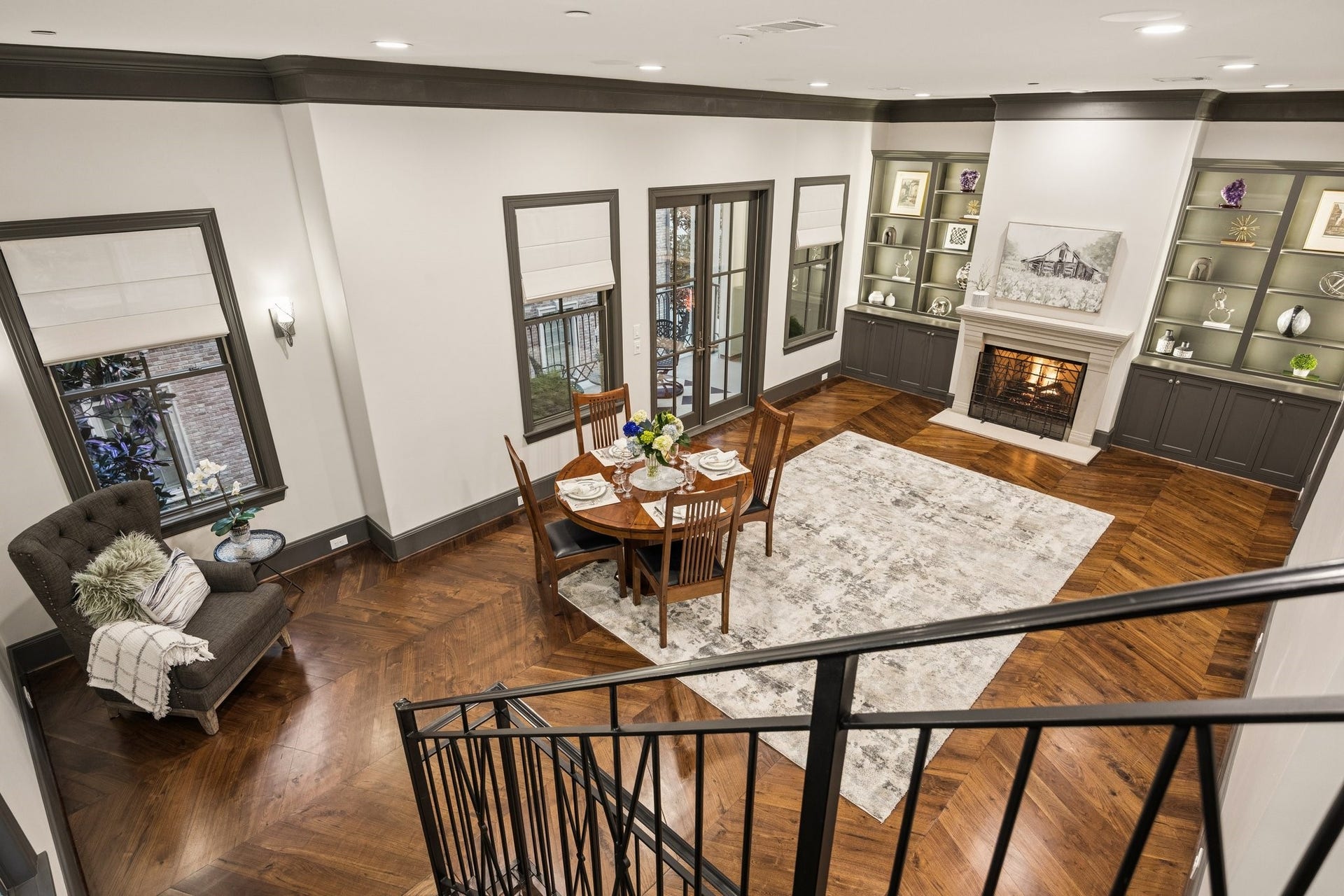 2131 Bancroft Street, Houston, TX 77027 Elegant formal living room with a fireplace, custom built-ins, and generous space for a dining area if desired. French doors open to a spacious private outdoor patio, perfect for relaxing and entertaining.