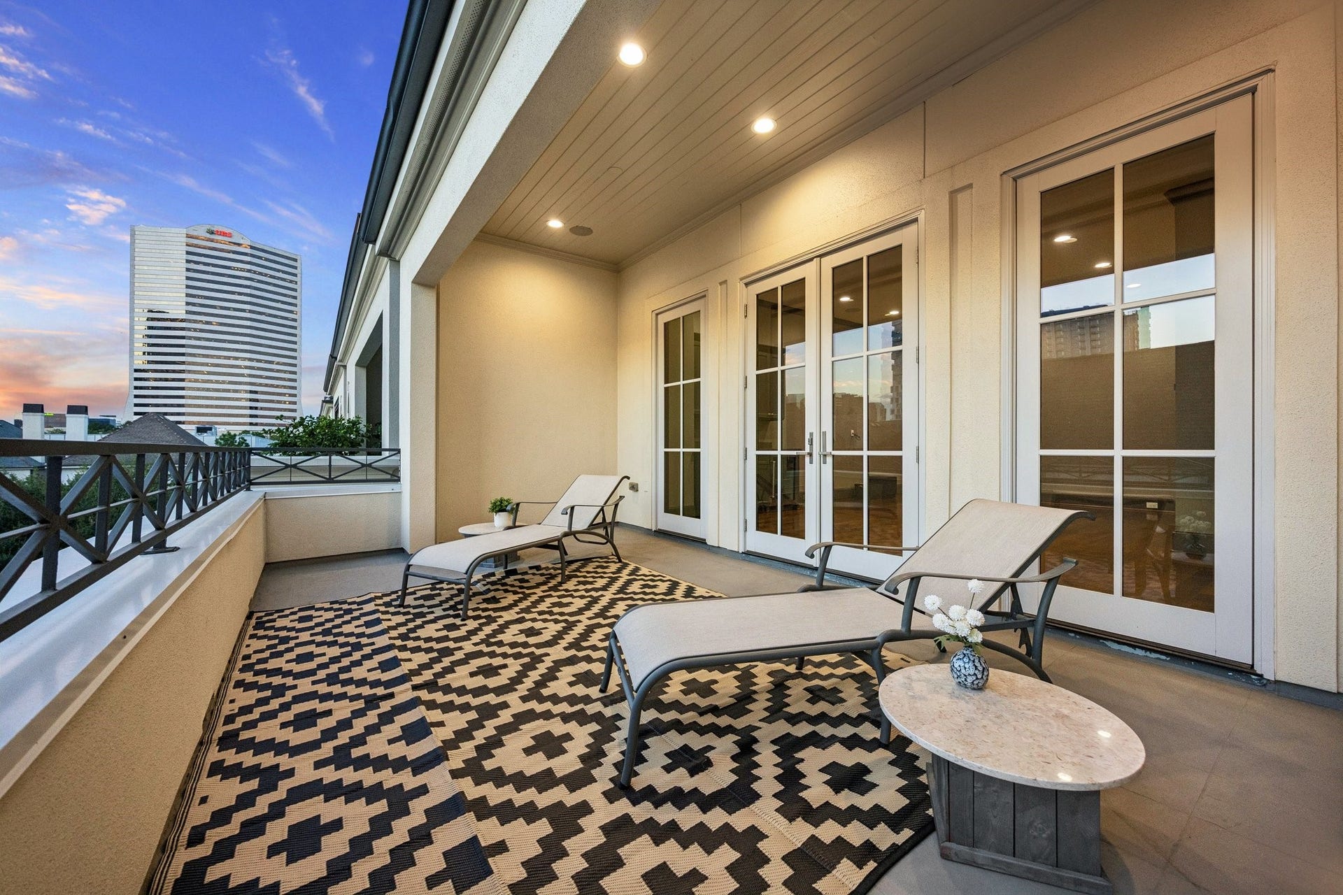 2131 Bancroft Street, Houston, TX 77027 Spacious fourth-floor covered terrace featuring motorized retractable screens, multiple French doors, ample room for outdoor lounging, and skyline viewsperfect for relaxing or entertaining.