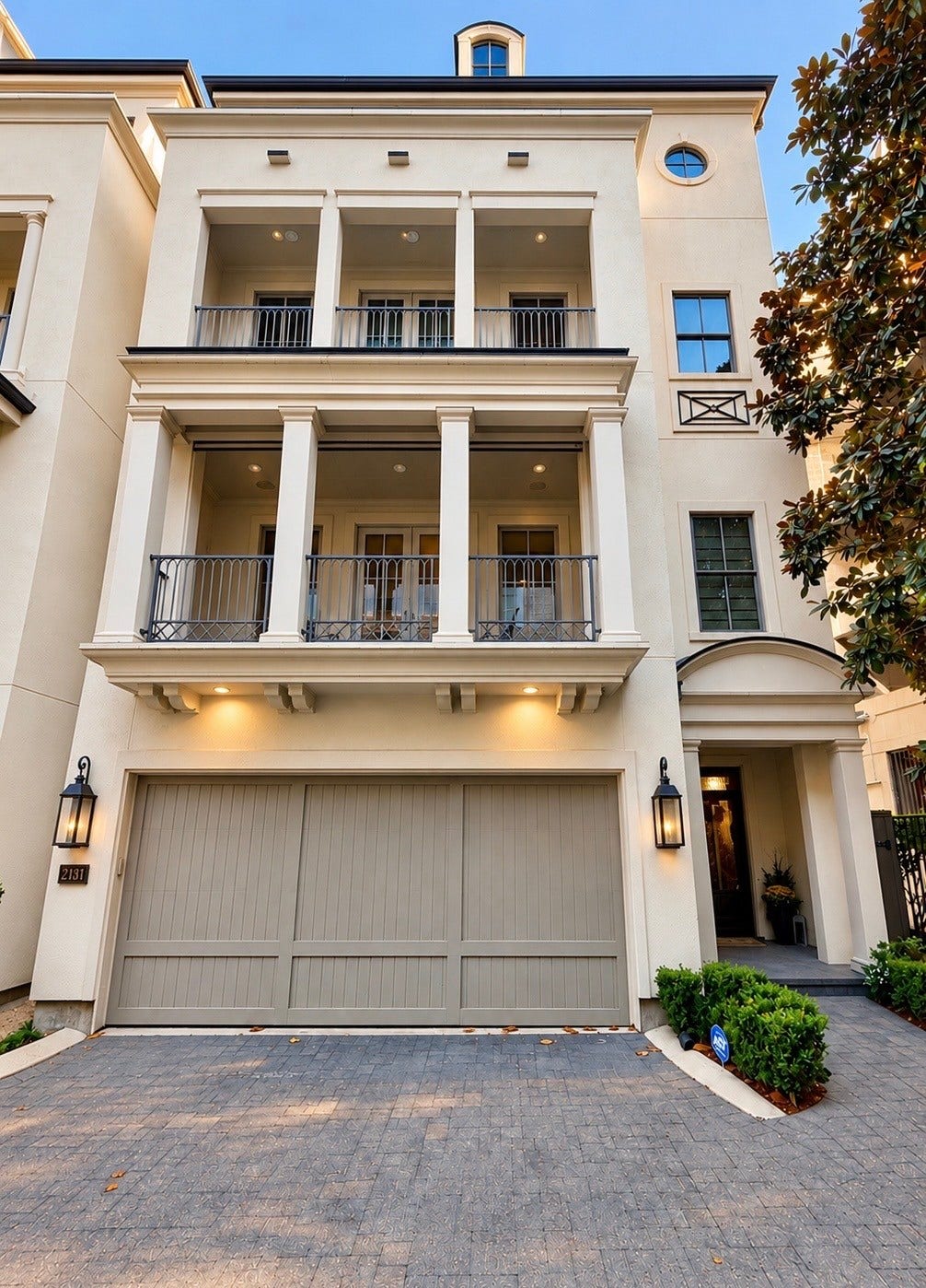 2131 Bancroft Street, Houston, TX 77027 Daylight view of this elegant luxury residence, showcasing timeless architecture, impressive balconies, and a private two-car garage within exclusive gated Bancroft Place.