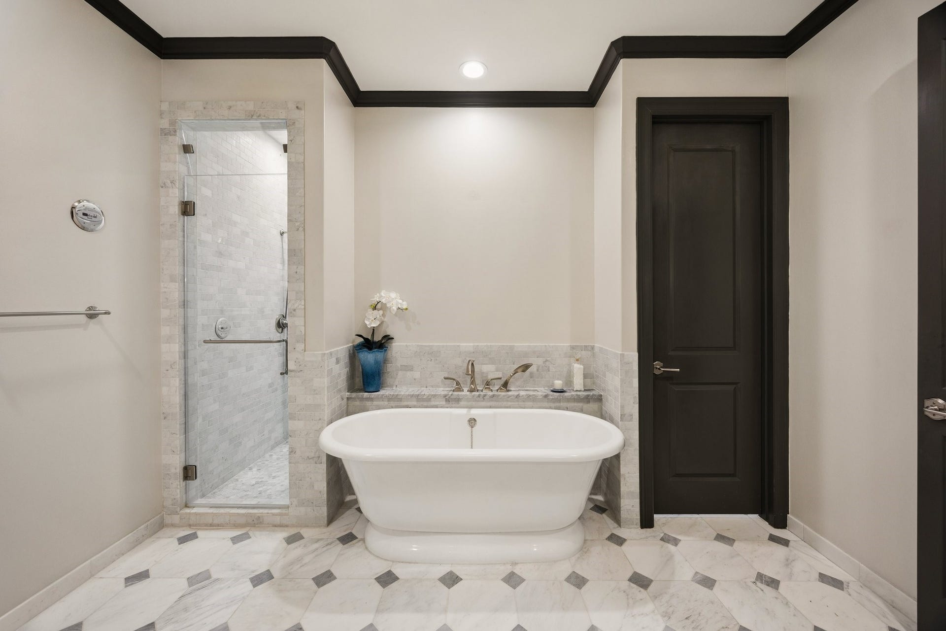 2131 Bancroft Street, Houston, TX 77027 Luxurious primary bathroom featuring a Victoria + Albert freestanding soaking tub, glass-enclosed steam shower, and exquisite marble flooring with decorative stone inlays.
