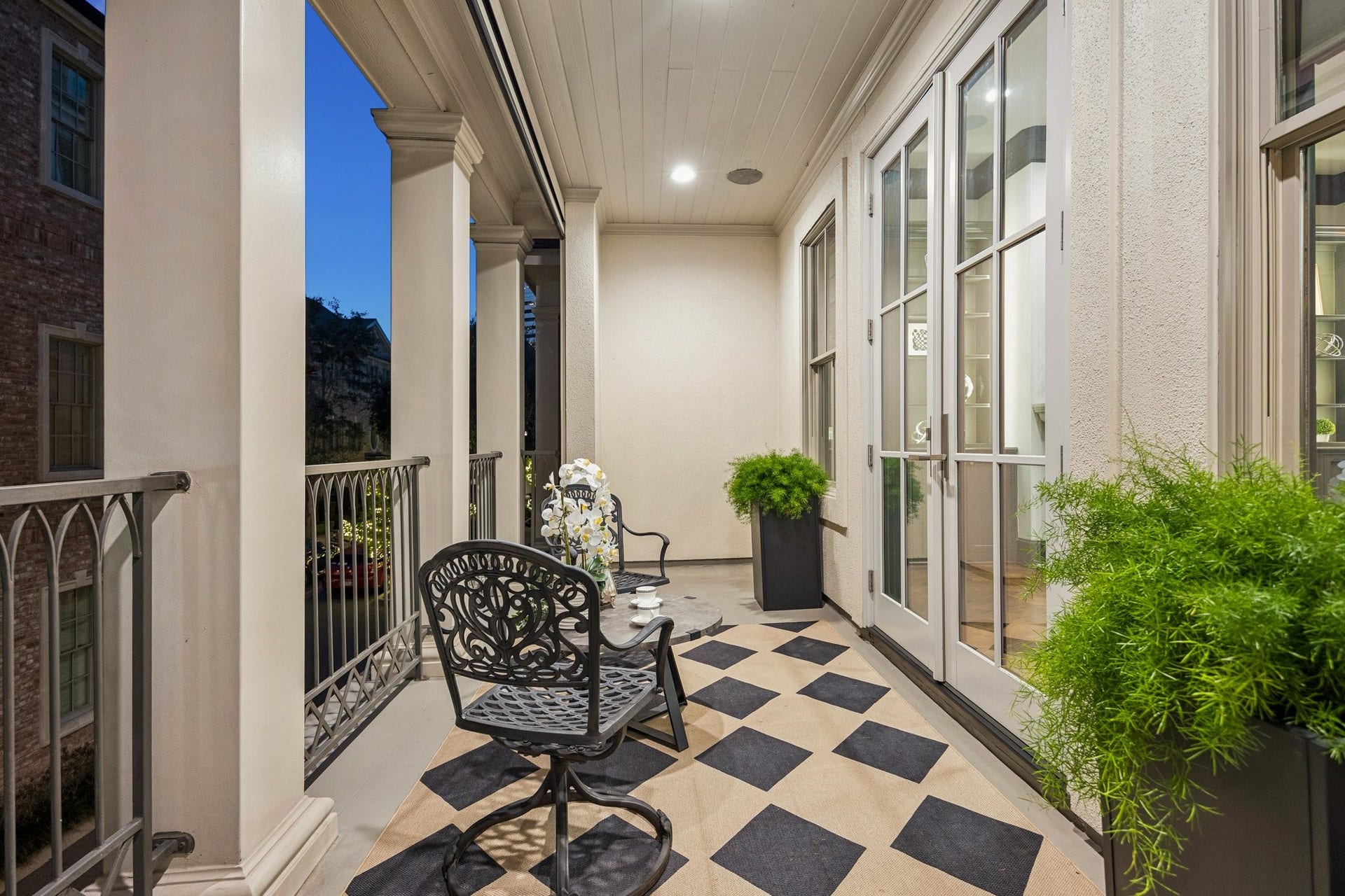 2131 Bancroft Street, Houston, TX 77027 Spacious covered balcony off the formal living room, featuring elegant columns, decorative railings, and ample room for outdoor seatingperfect for morning coffee or evening relaxation.