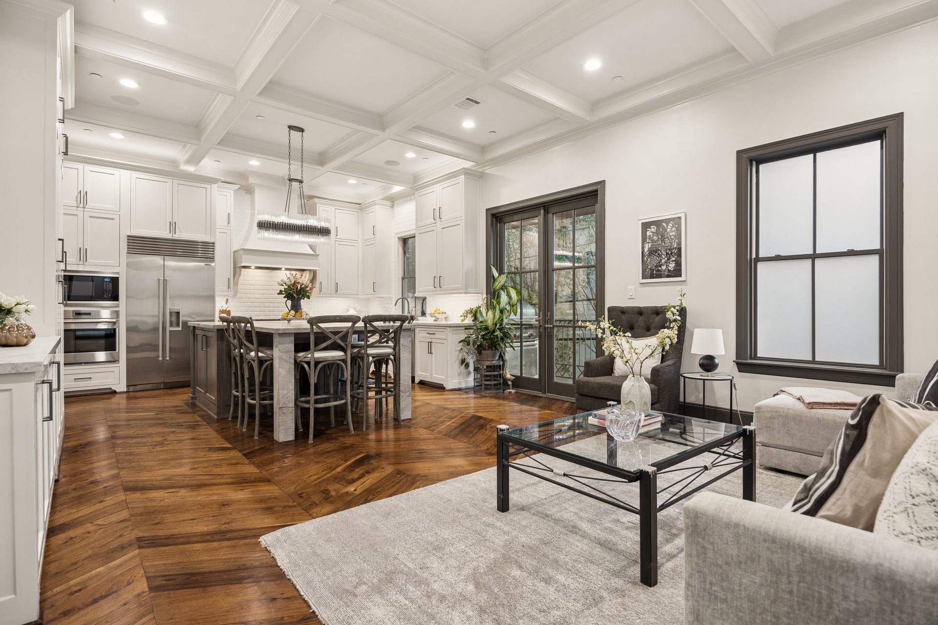 2131 Bancroft Street, Houston, TX 77027 Beautiful open-concept living and kitchen area with French doors opening to a private outdoor patio featuring a gas grillperfect for effortless indoor-outdoor entertaining.