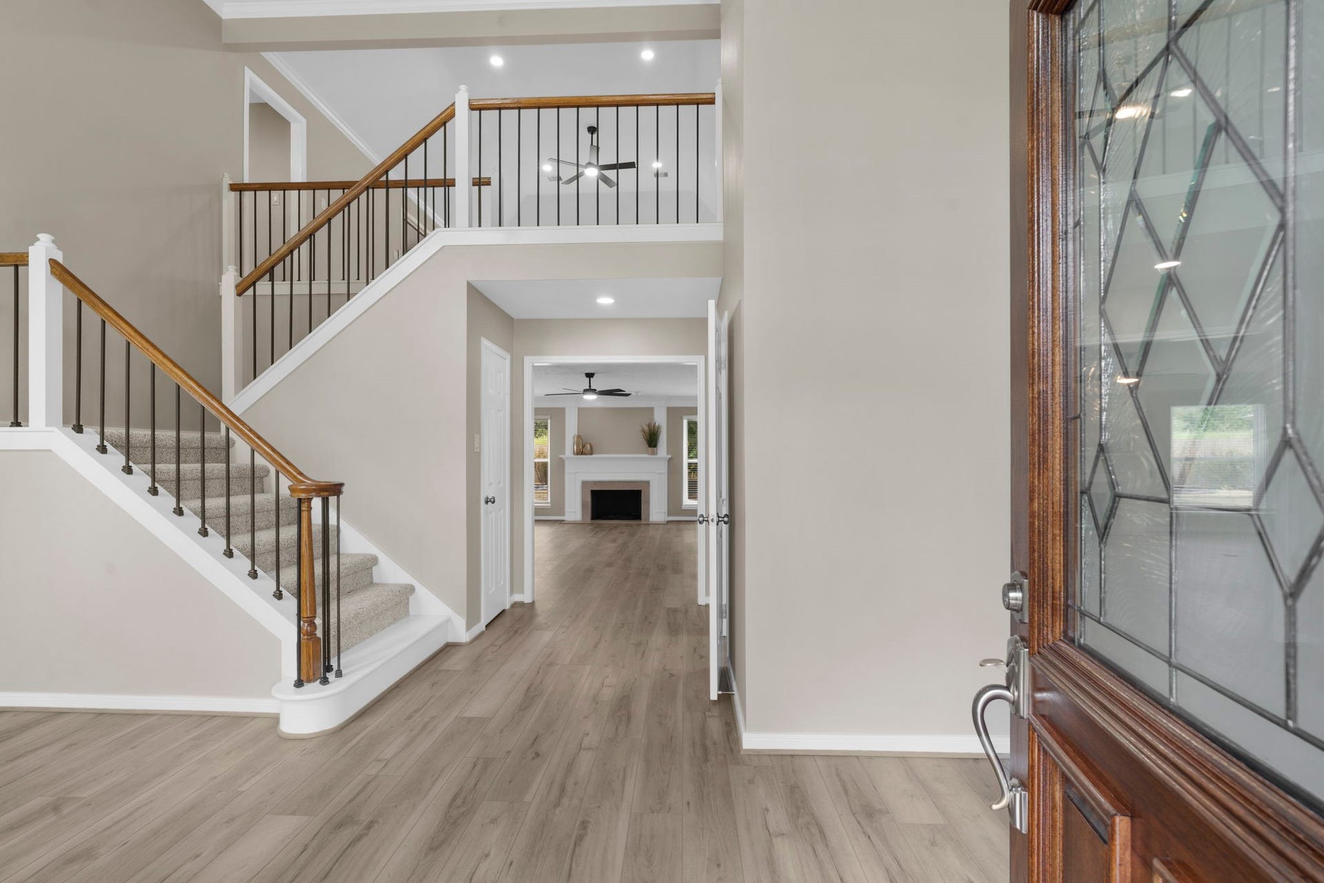 75 Stalybridge Street, Sugar Land, TX 77479 Step inside to a bright two-story foyer featuring wrought iron staircase spindles, fresh designer paint & updated flooring. The open sightline draws you through the home toward the family room beyond.