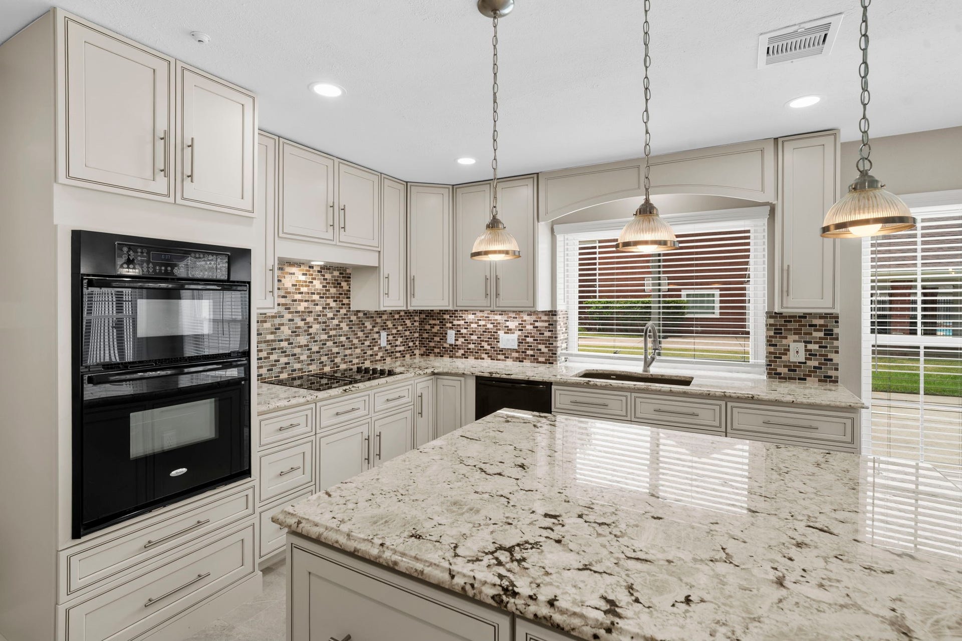 75 Stalybridge Street, Sugar Land, TX 77479 A closer look highlights the kitchens exceptional storage with cabinetry extending throughout, complemented by a generous island & multiple prep surfaces. Pendant and recessed lighting keep the space bright & functional.